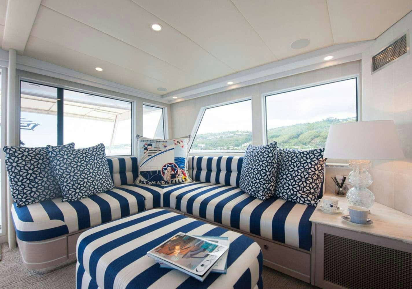 a living room with a blue couch aboard SHORETHING Yacht for Charter