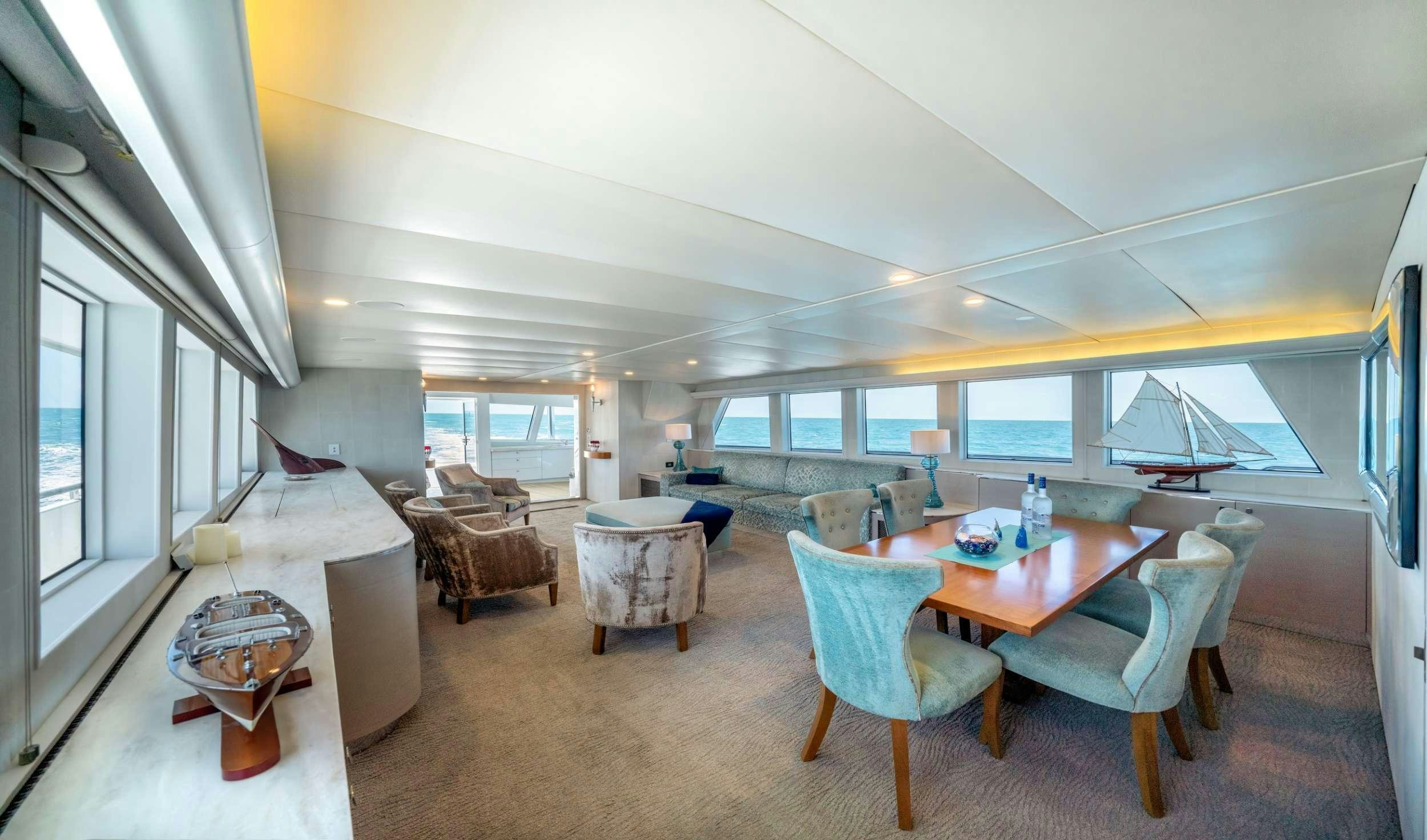 a living room with a table and chairs aboard SHORETHING Yacht for Charter