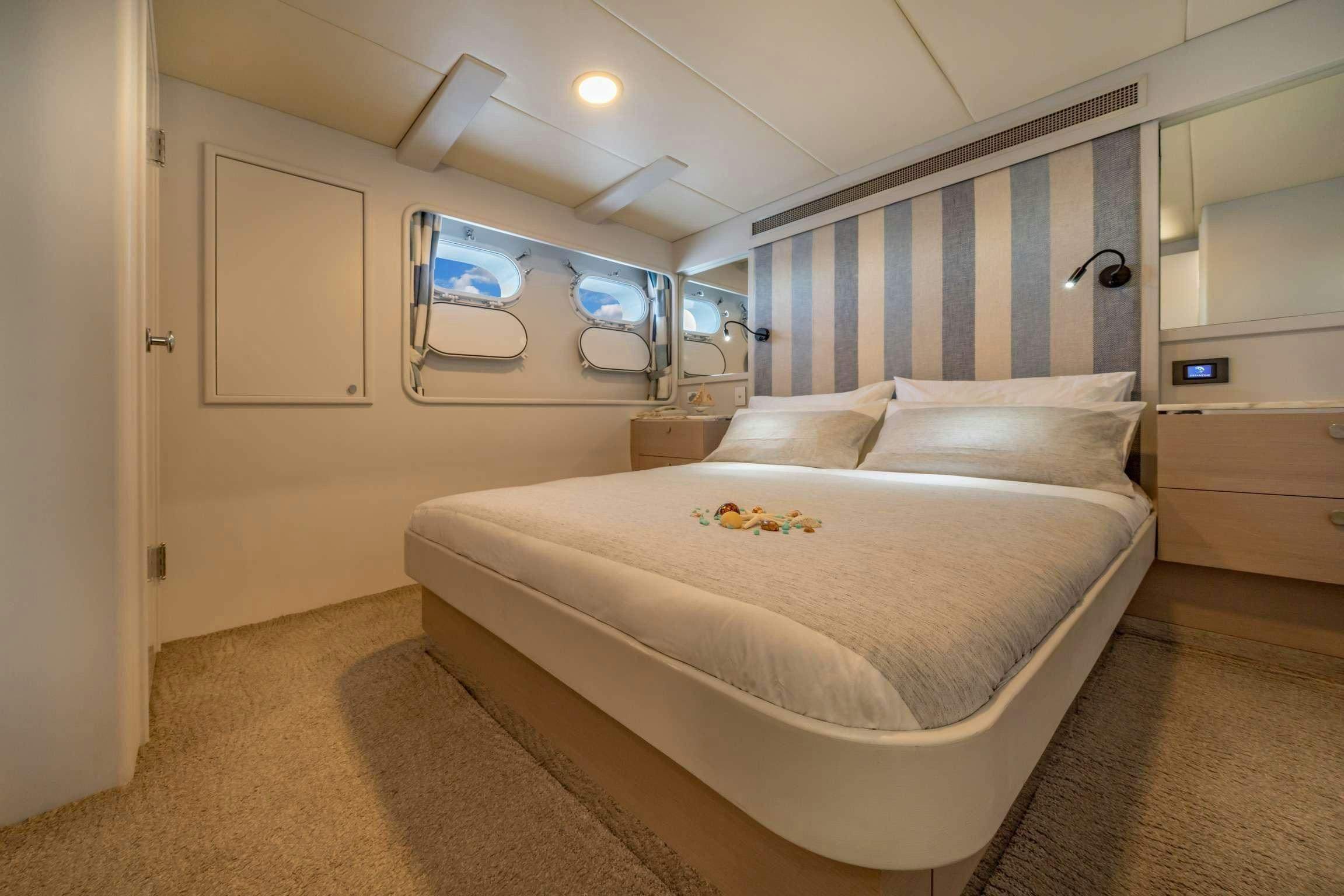 a bedroom with a bed aboard SHORETHING Yacht for Charter