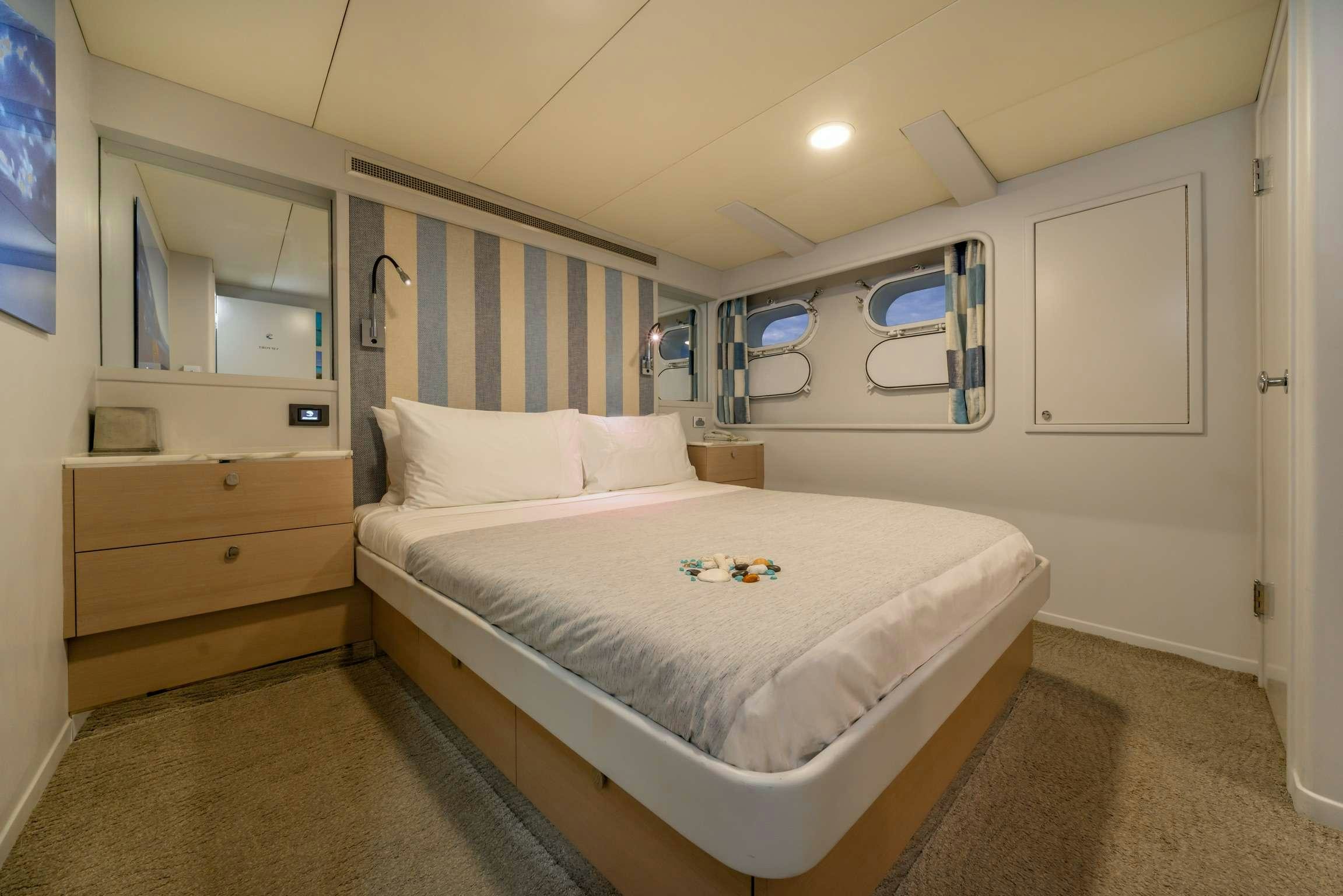 a bedroom with a bed and a desk aboard SHORETHING Yacht for Charter