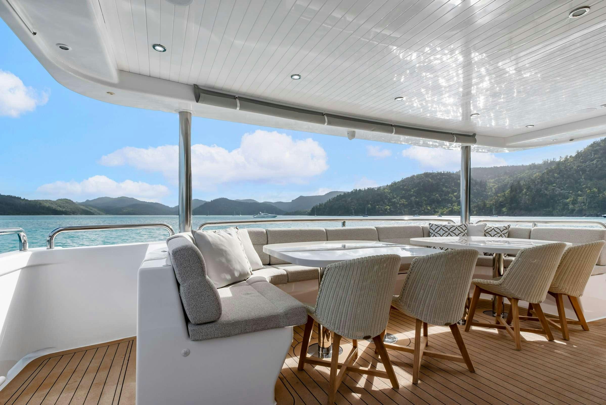 a deck with chairs and tables aboard MATRIX III Yacht for Charter