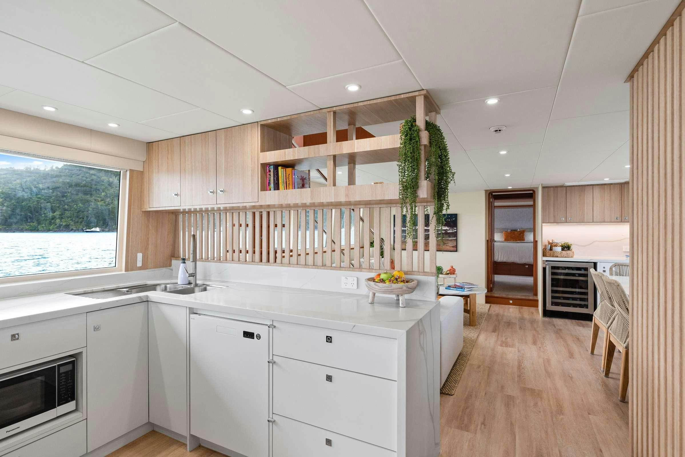 a kitchen with wooden cabinets aboard MATRIX III Yacht for Charter