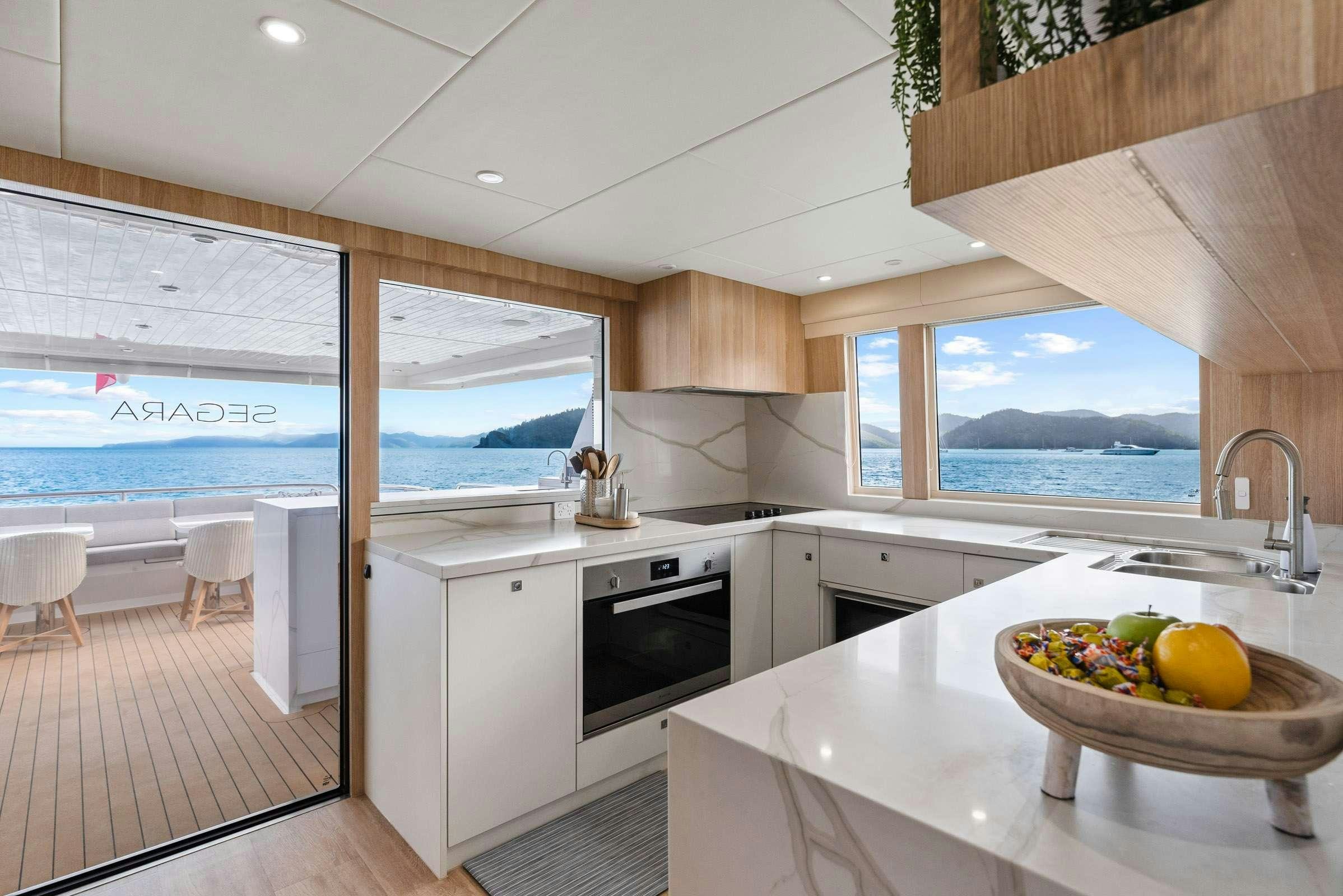 a kitchen with a large window aboard MATRIX III Yacht for Charter