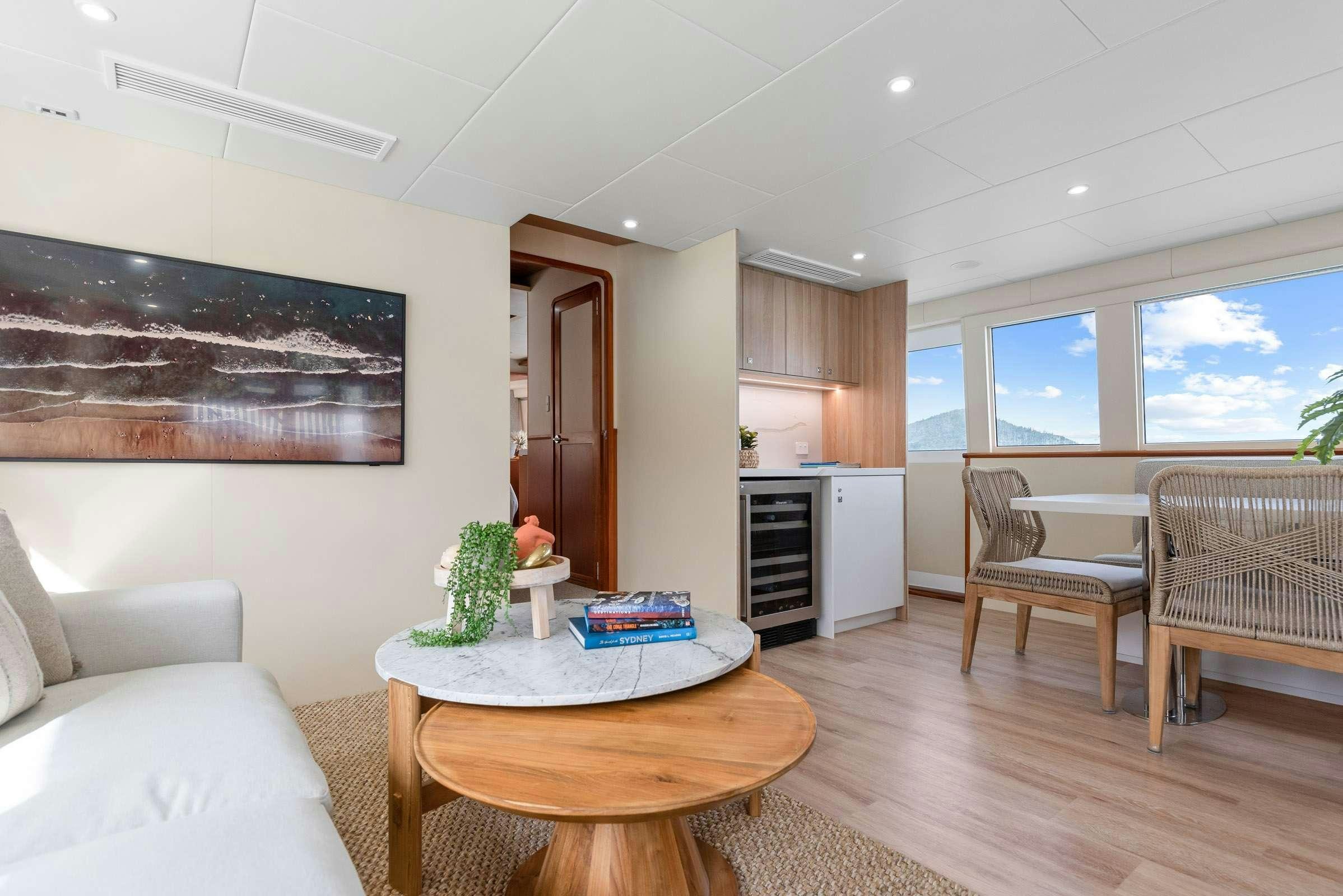 a living room with a table and chairs aboard MATRIX III Yacht for Charter