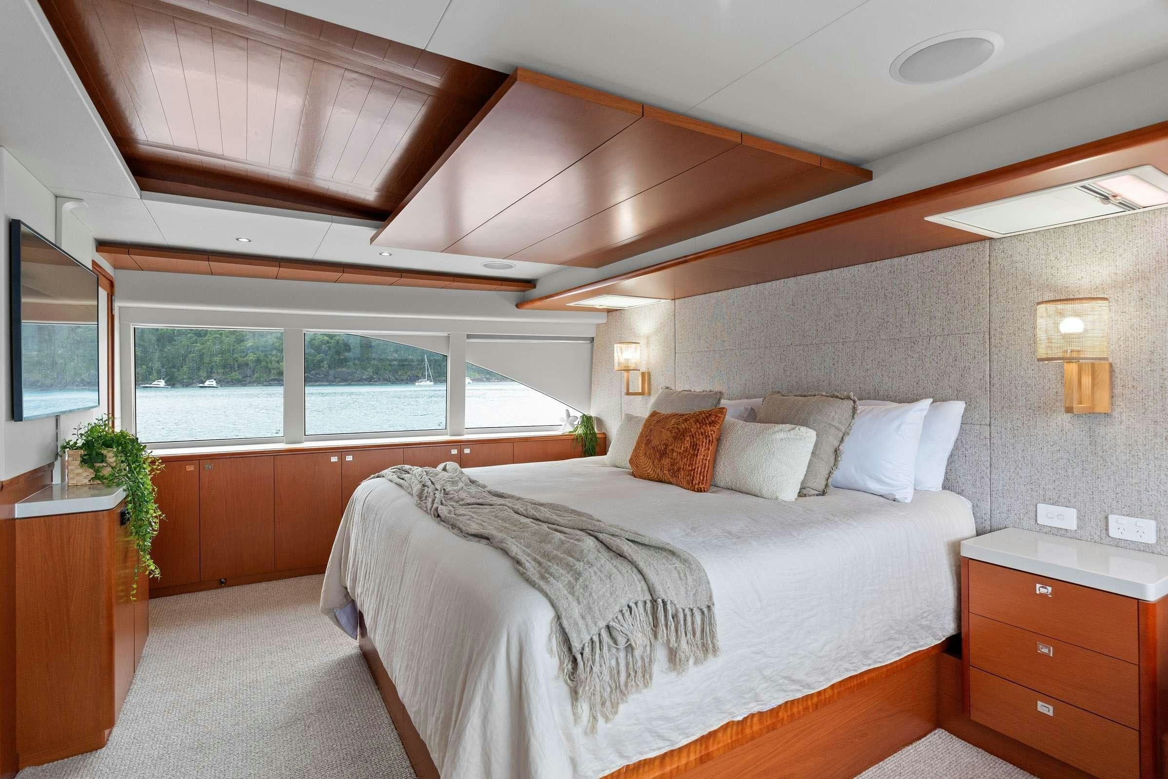 a bedroom with a large bed aboard MATRIX III Yacht for Charter