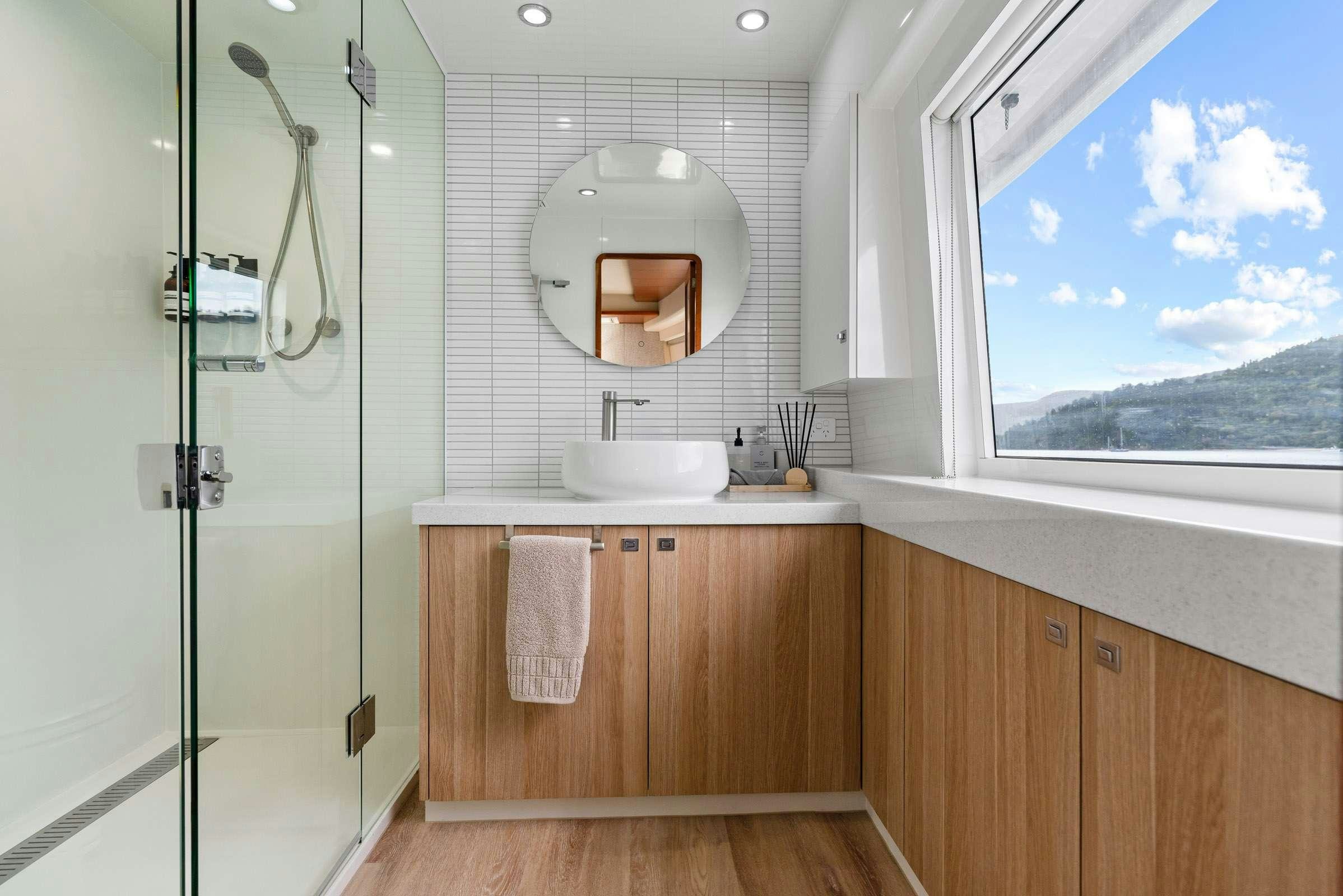 a bathroom with a shower and sink aboard MATRIX III Yacht for Charter