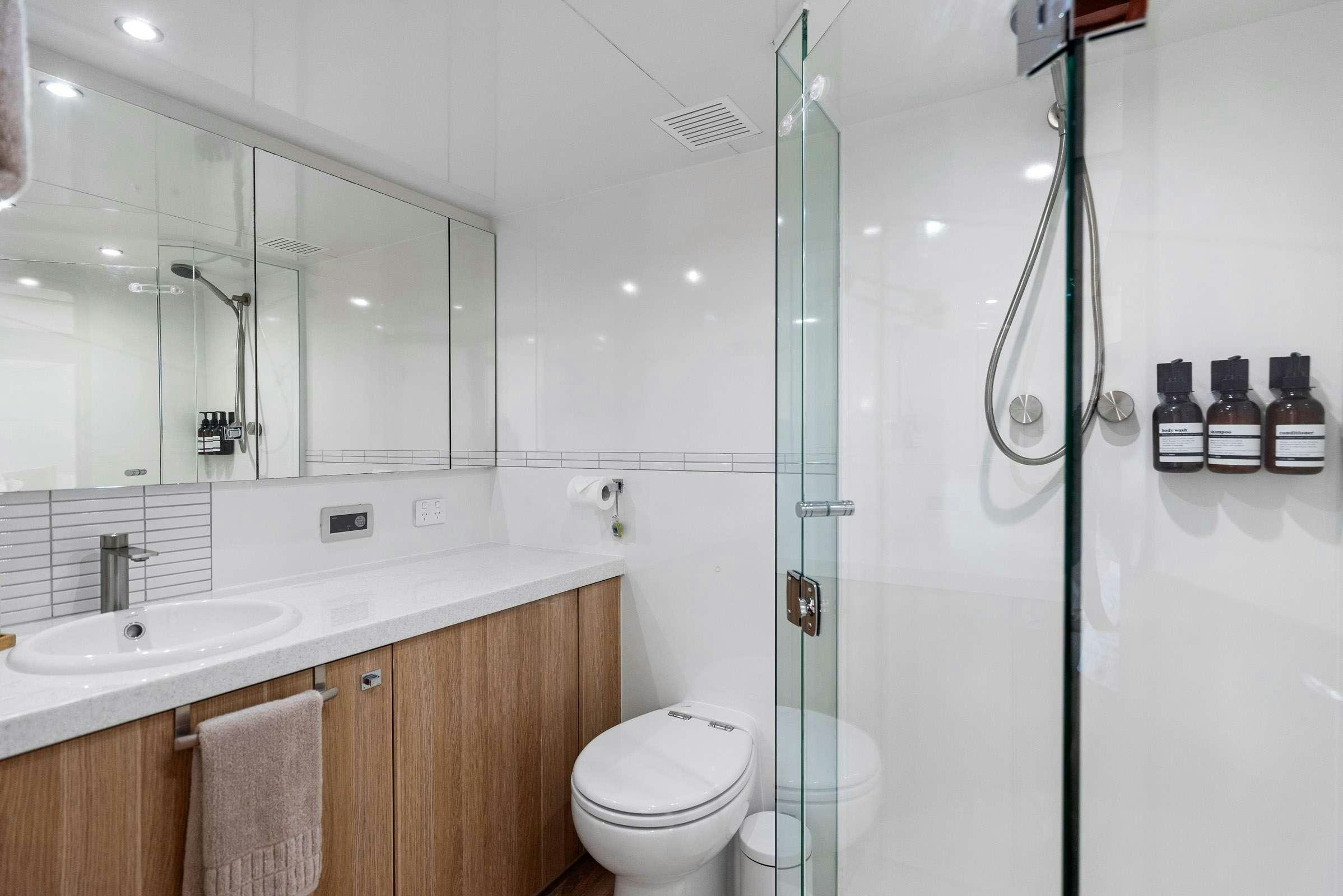 a bathroom with a shower and sink aboard MATRIX III Yacht for Charter