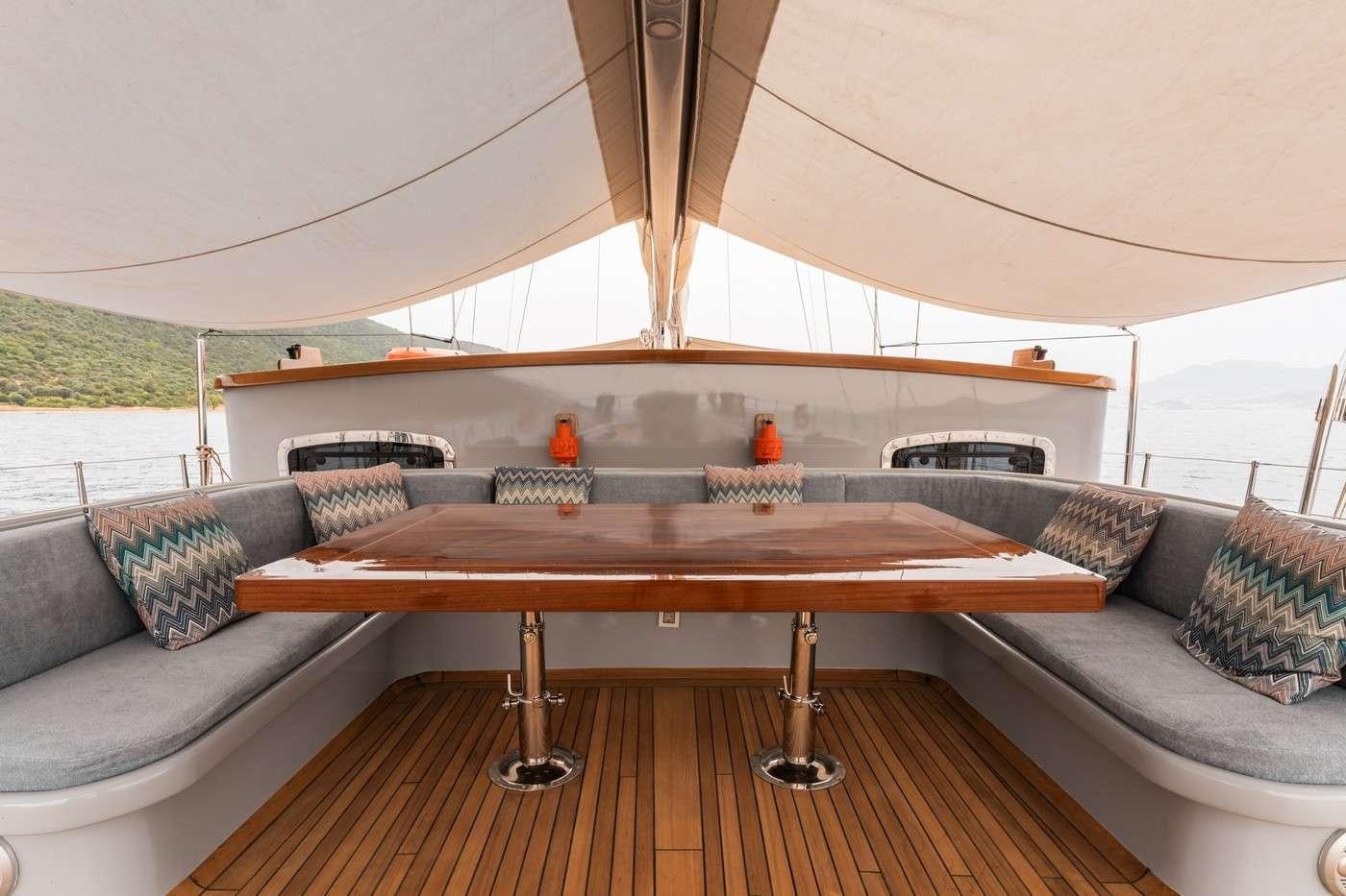 a living room with a couch and a table aboard MONE Yacht for Charter