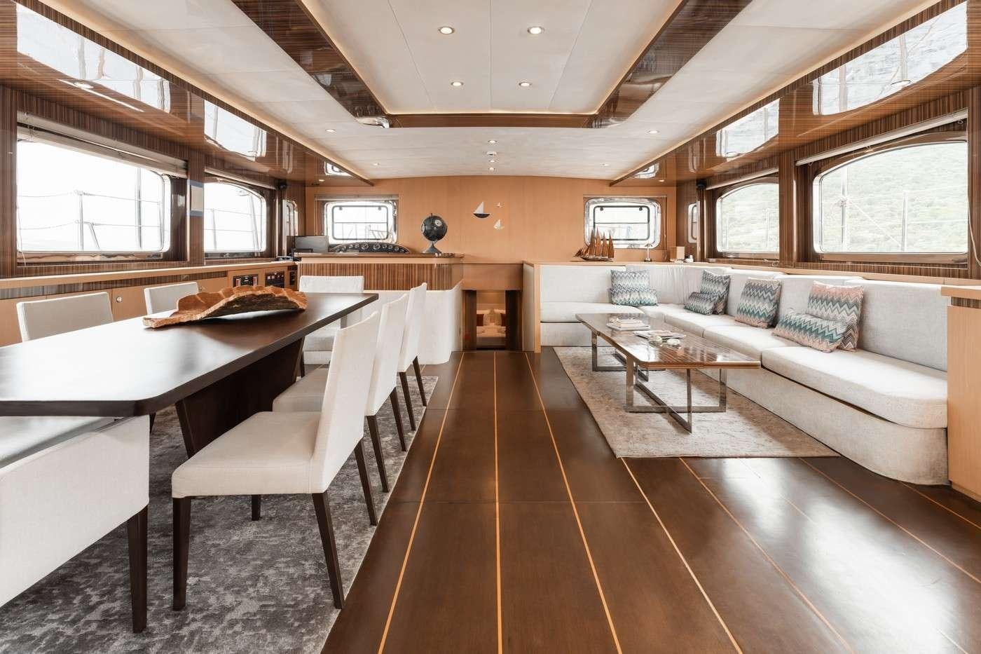 a room with a couch and a table aboard MONE Yacht for Charter