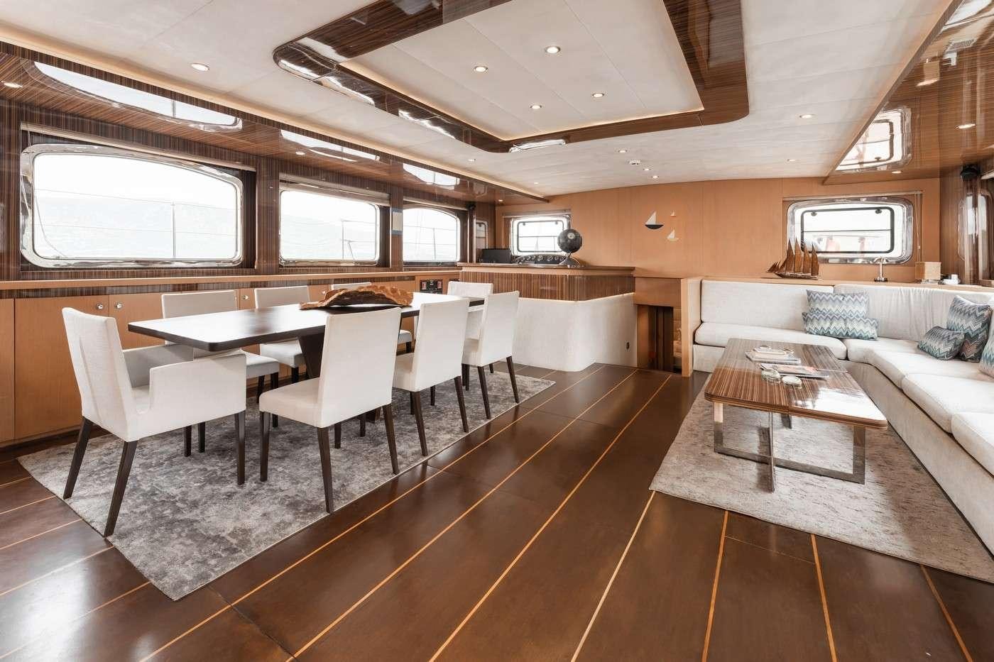 a room with a couch and a table and chairs aboard MONE Yacht for Charter