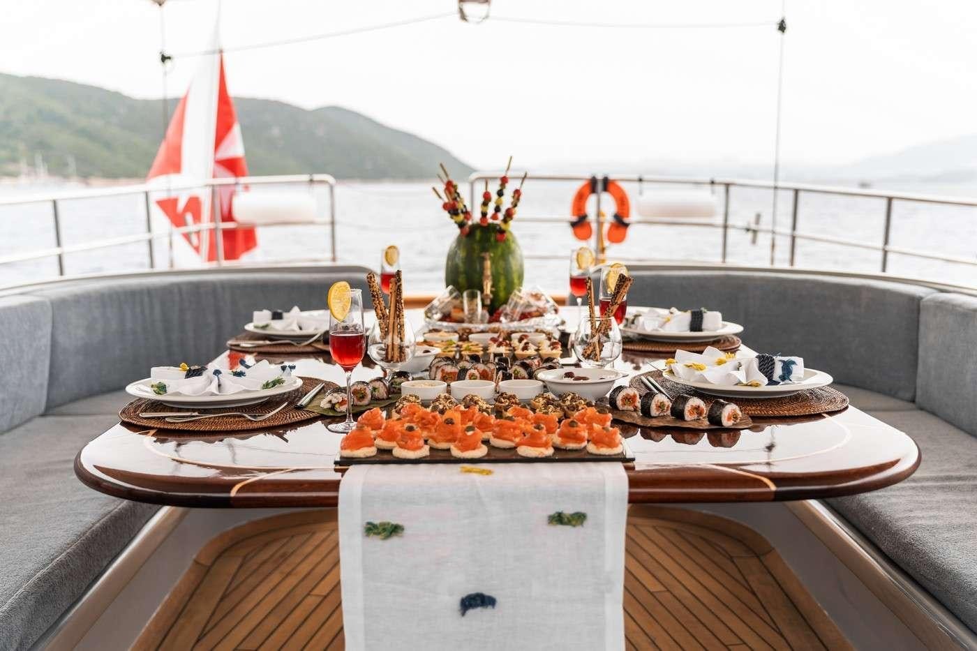 a table with food and drinks on it aboard MONE Yacht for Charter