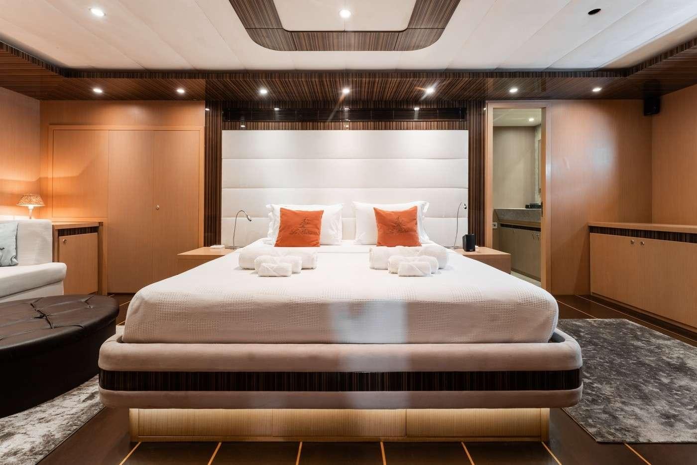 a bed with pillows aboard MONE Yacht for Charter