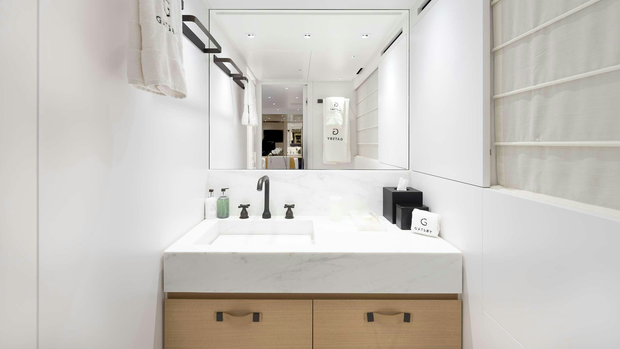 a bathroom with a sink and mirror aboard GATSBY Yacht for Charter