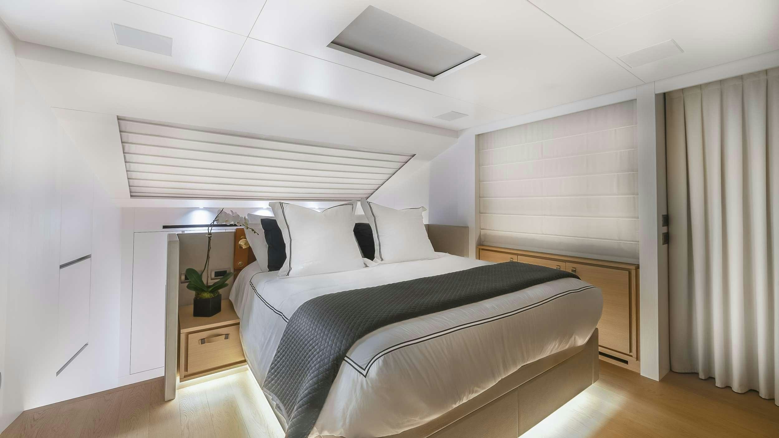 a bedroom with a bed and a desk aboard GATSBY Yacht for Charter