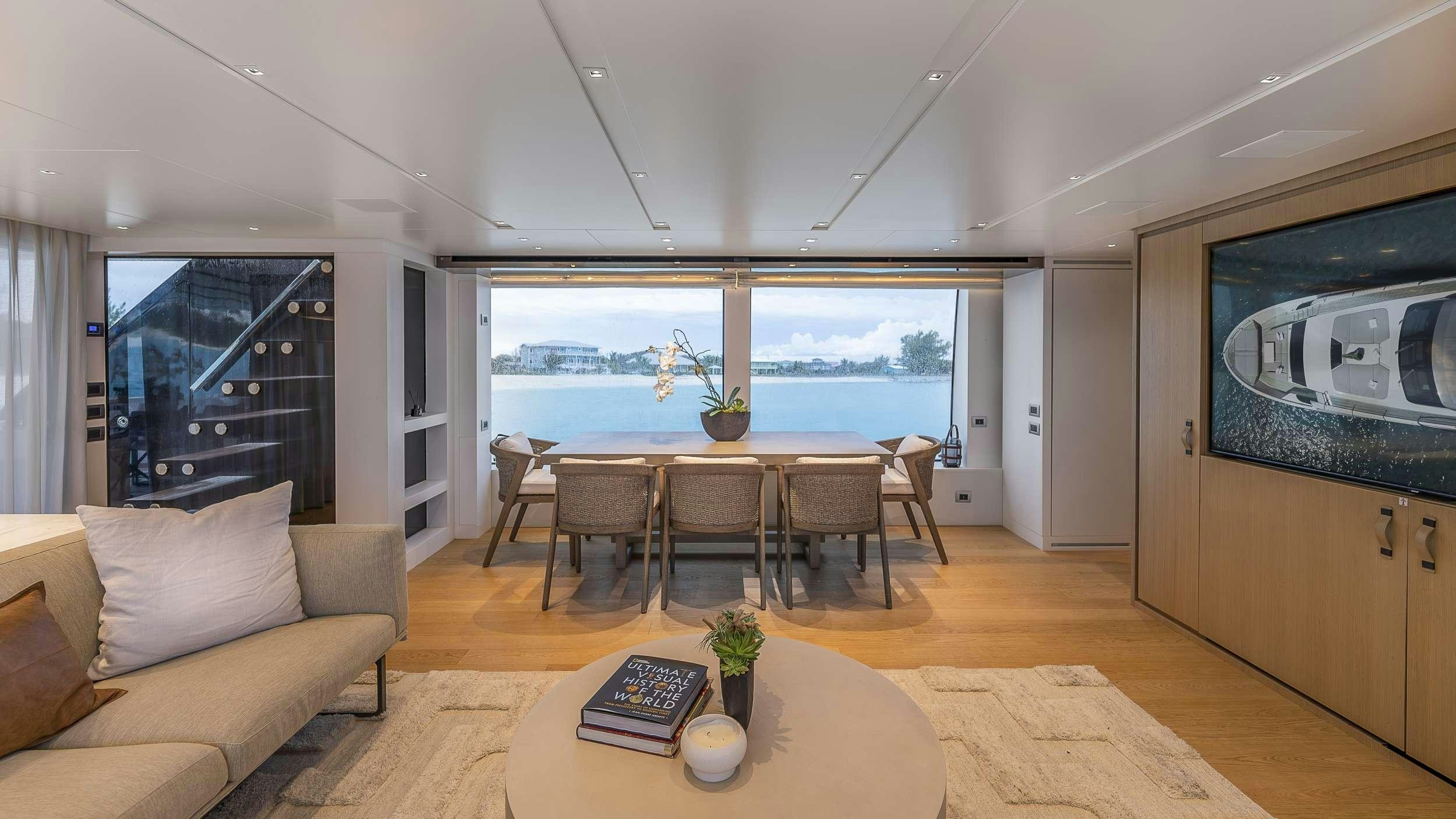 a living room with a table and chairs aboard GATSBY Yacht for Charter