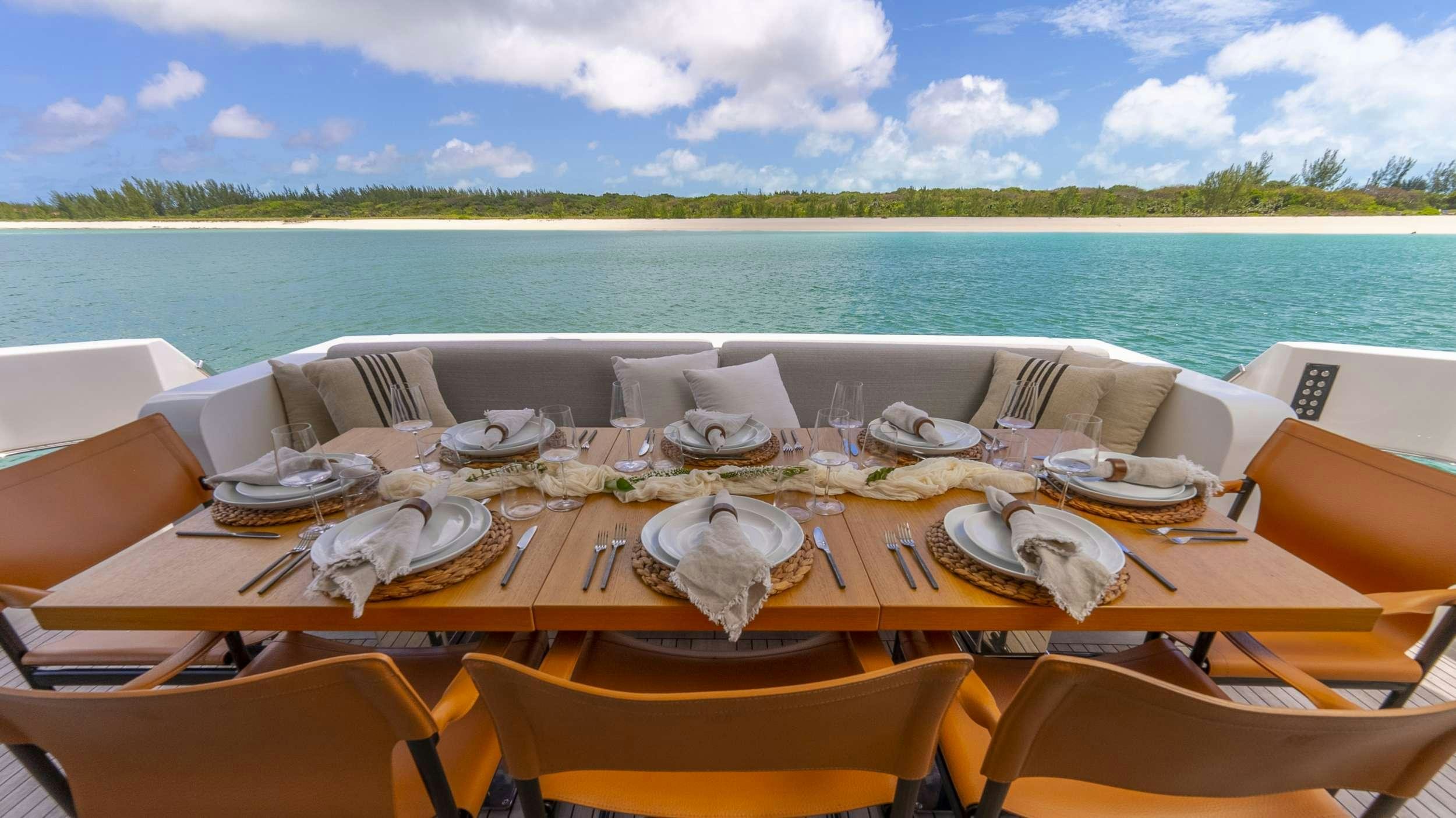 a table set for a dinner on a boat aboard GATSBY Yacht for Charter