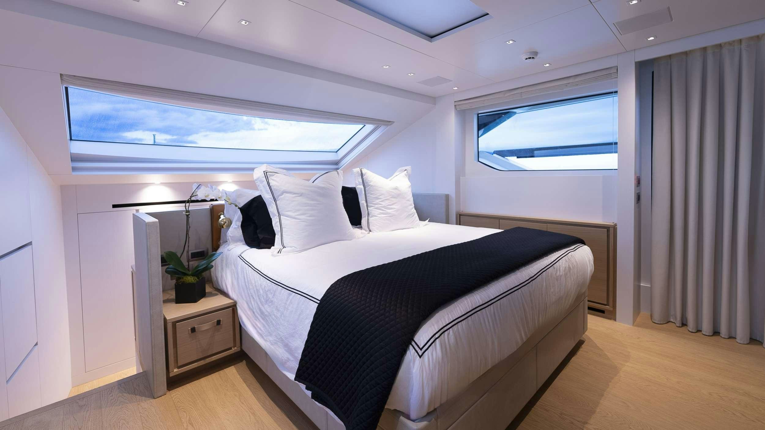 a bedroom with a bed and a desk aboard GATSBY Yacht for Charter