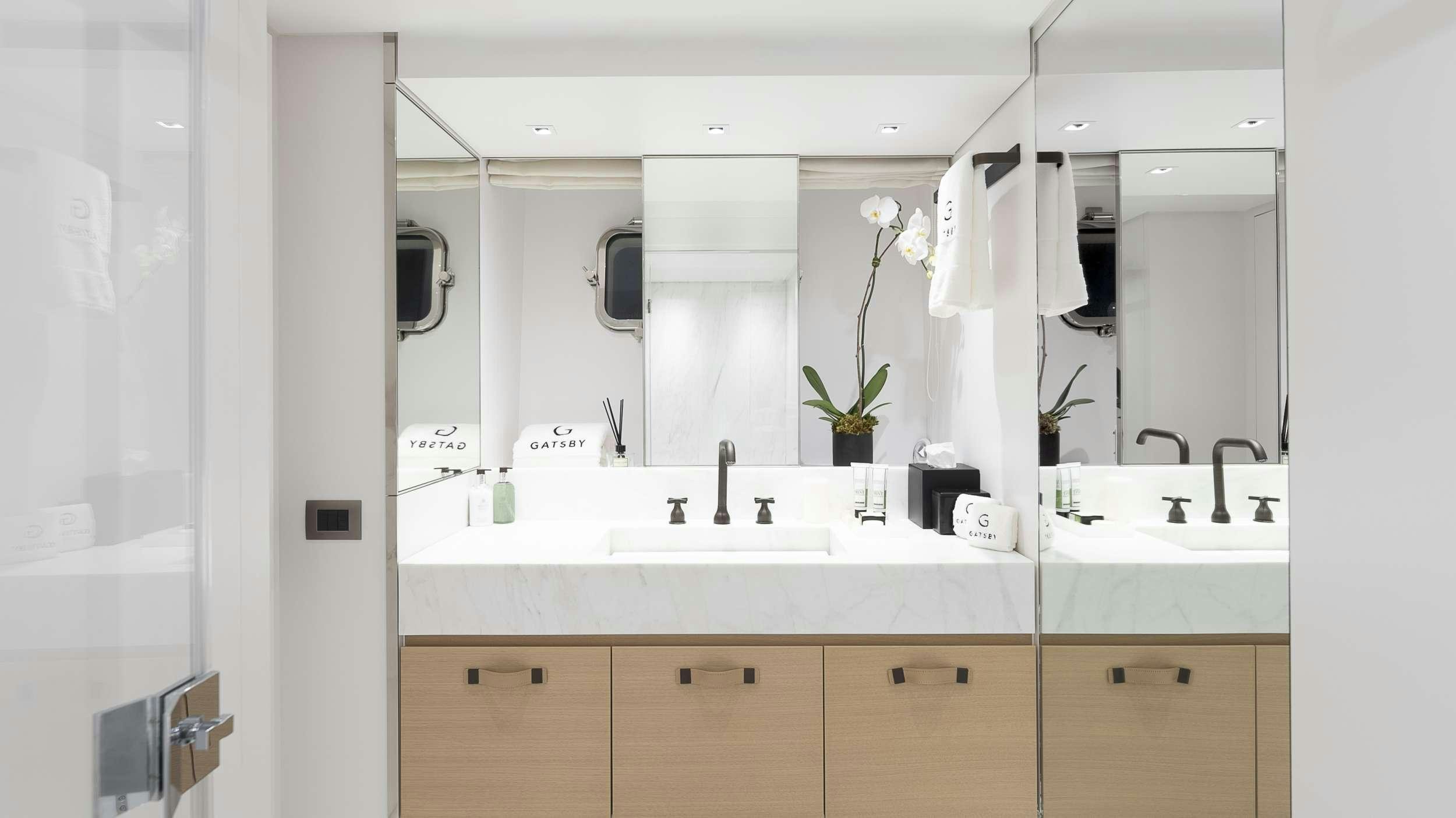 a bathroom with a large mirror aboard GATSBY Yacht for Charter