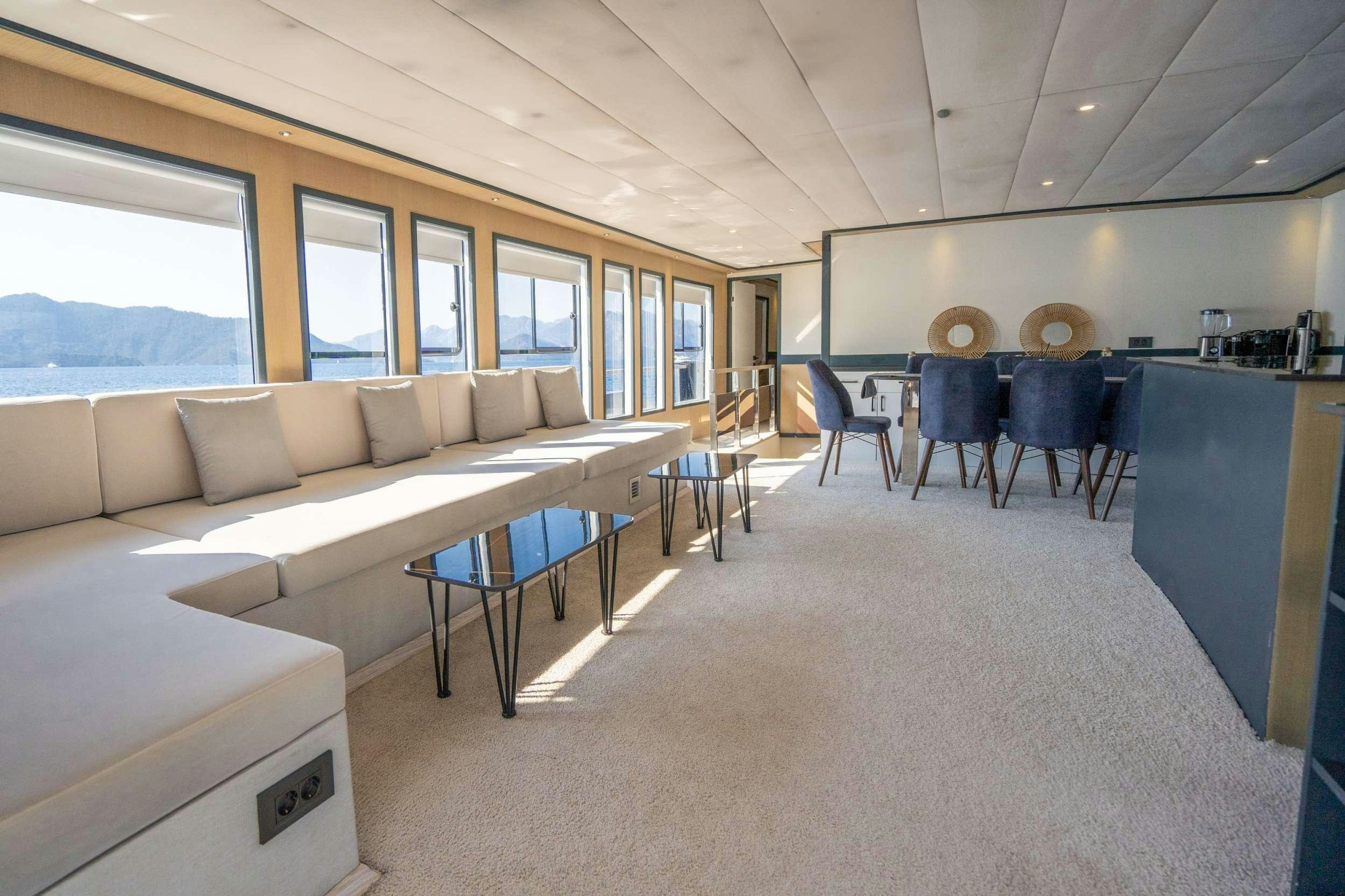 a living room with a couch and a table aboard IMPACT Yacht for Charter
