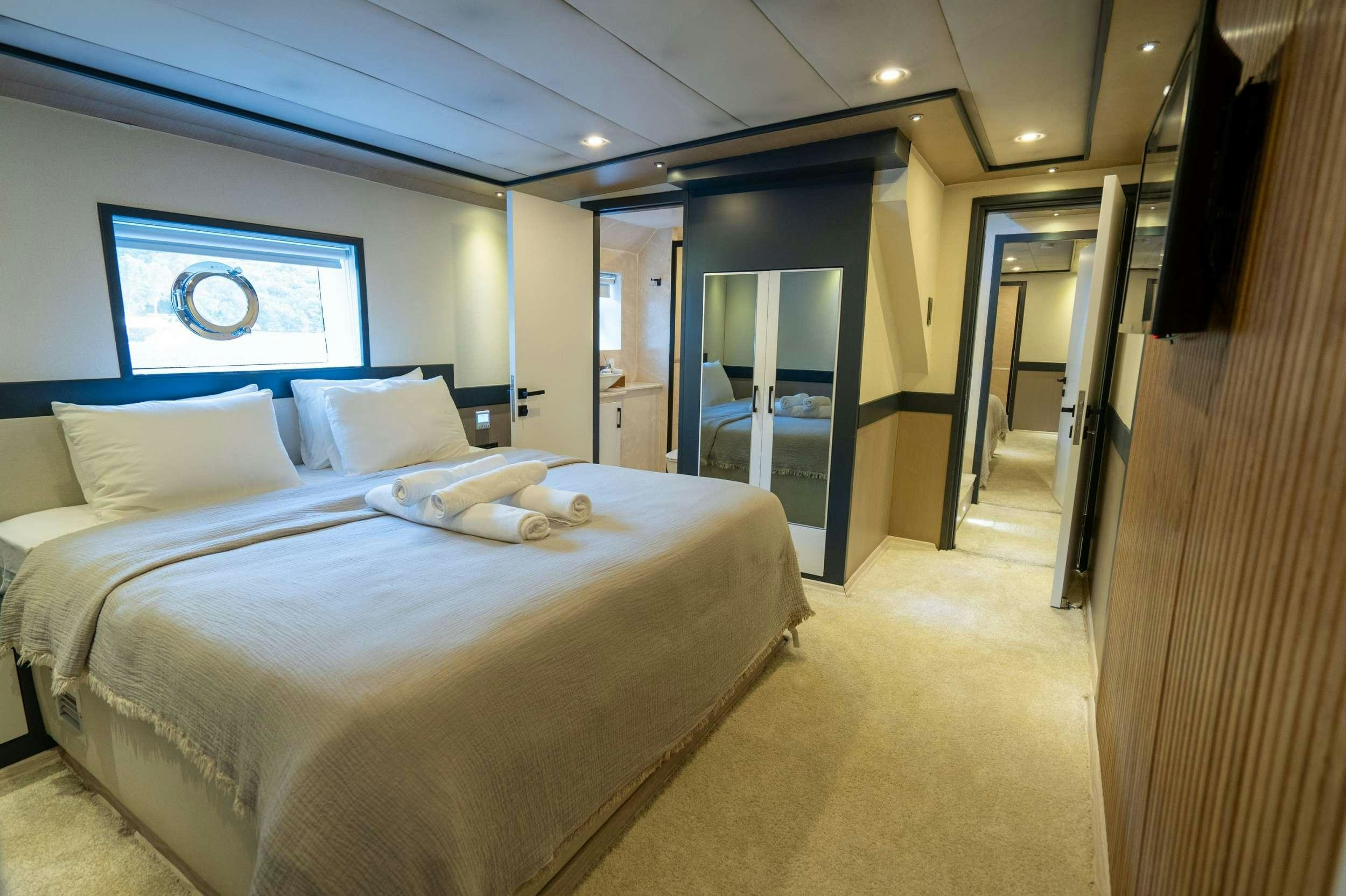 a hotel room with a bed aboard IMPACT Yacht for Charter