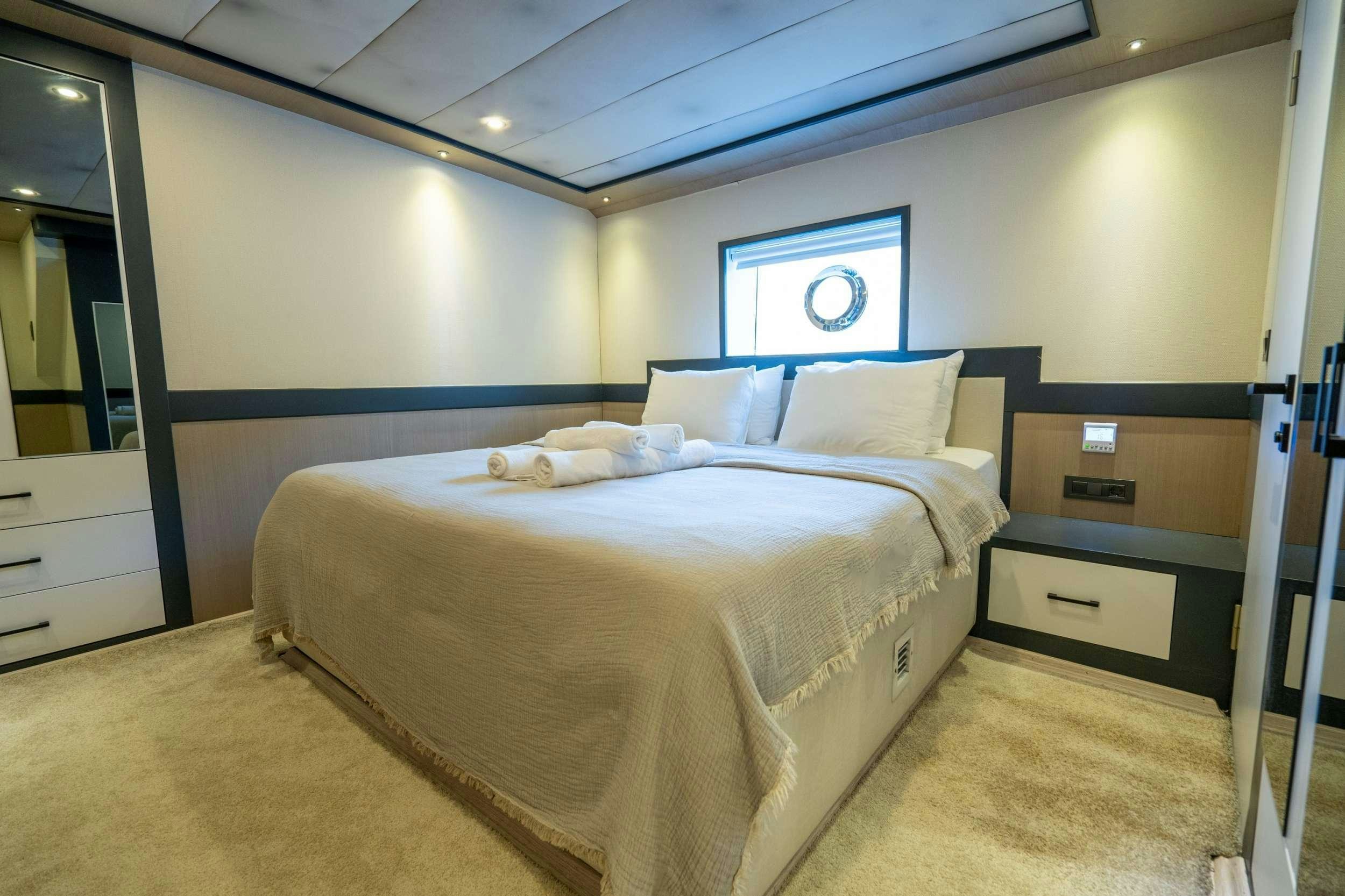 a room with two beds aboard IMPACT Yacht for Charter