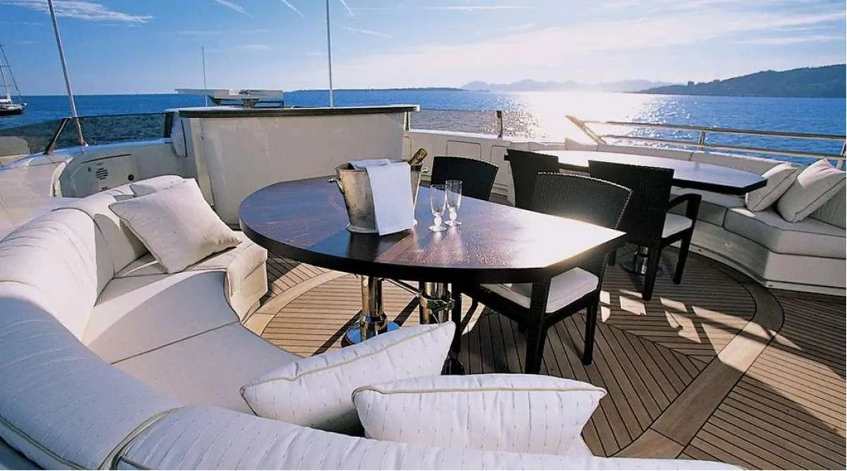 a table and chairs on a deck aboard PENELOPE Yacht for Charter