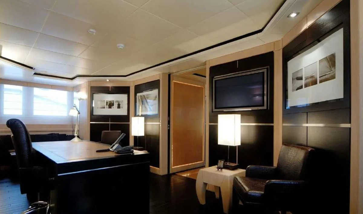a room with a desk and a tv aboard PENELOPE Yacht for Charter
