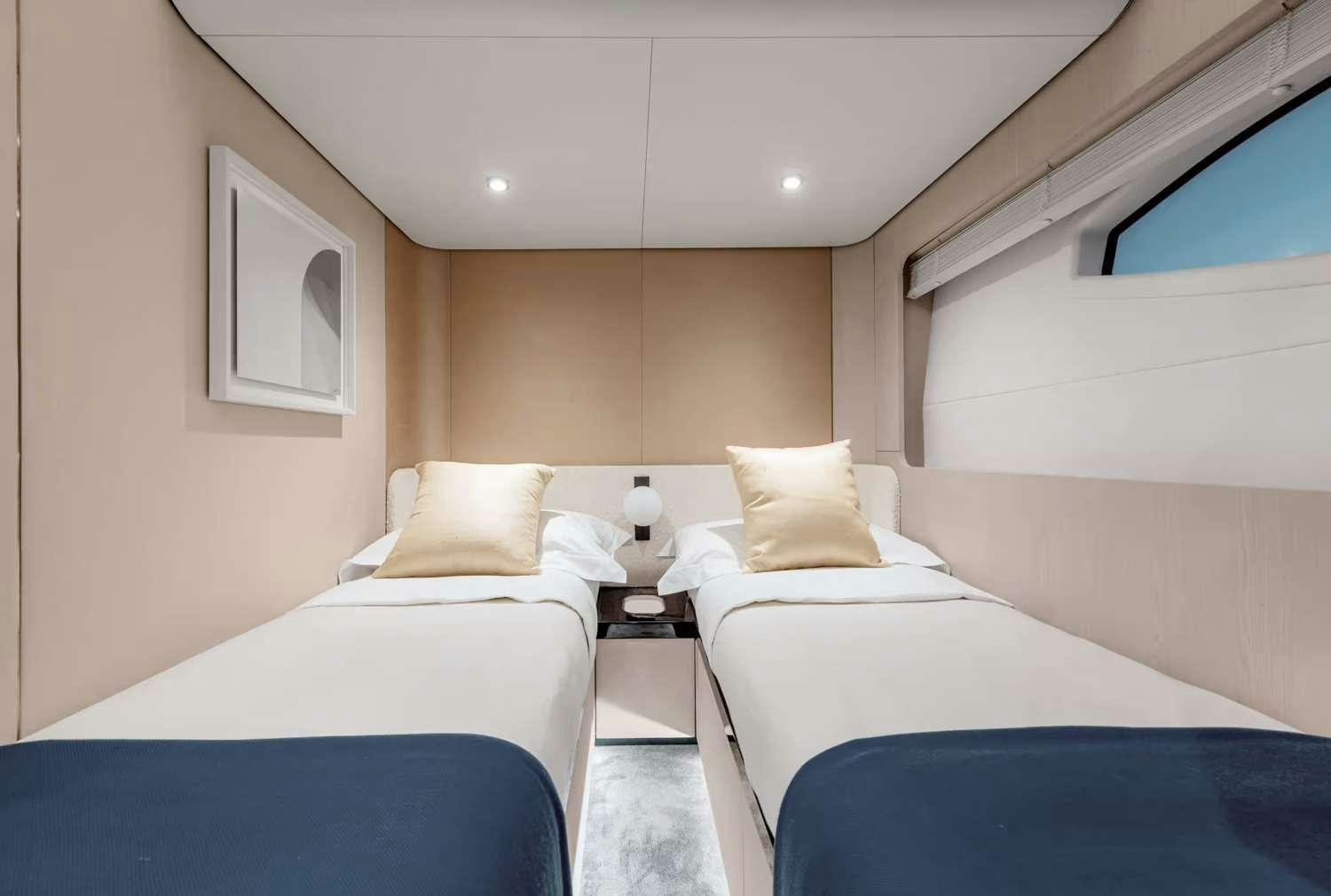 a couple of beds in a hotel room aboard DT78 Yacht for Charter