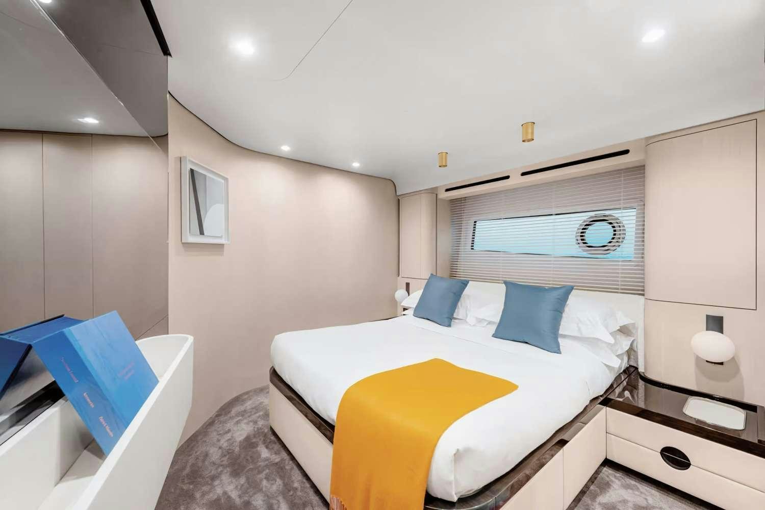 a bedroom with a bed and a desk aboard DT78 Yacht for Charter