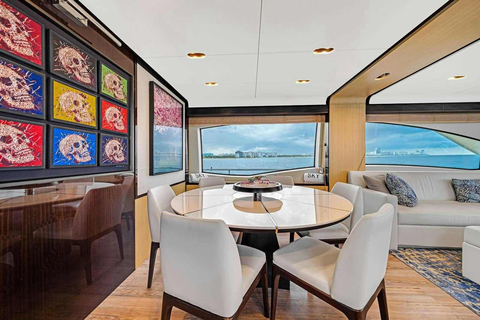 a room with a table and chairs aboard SKY Yacht for Charter