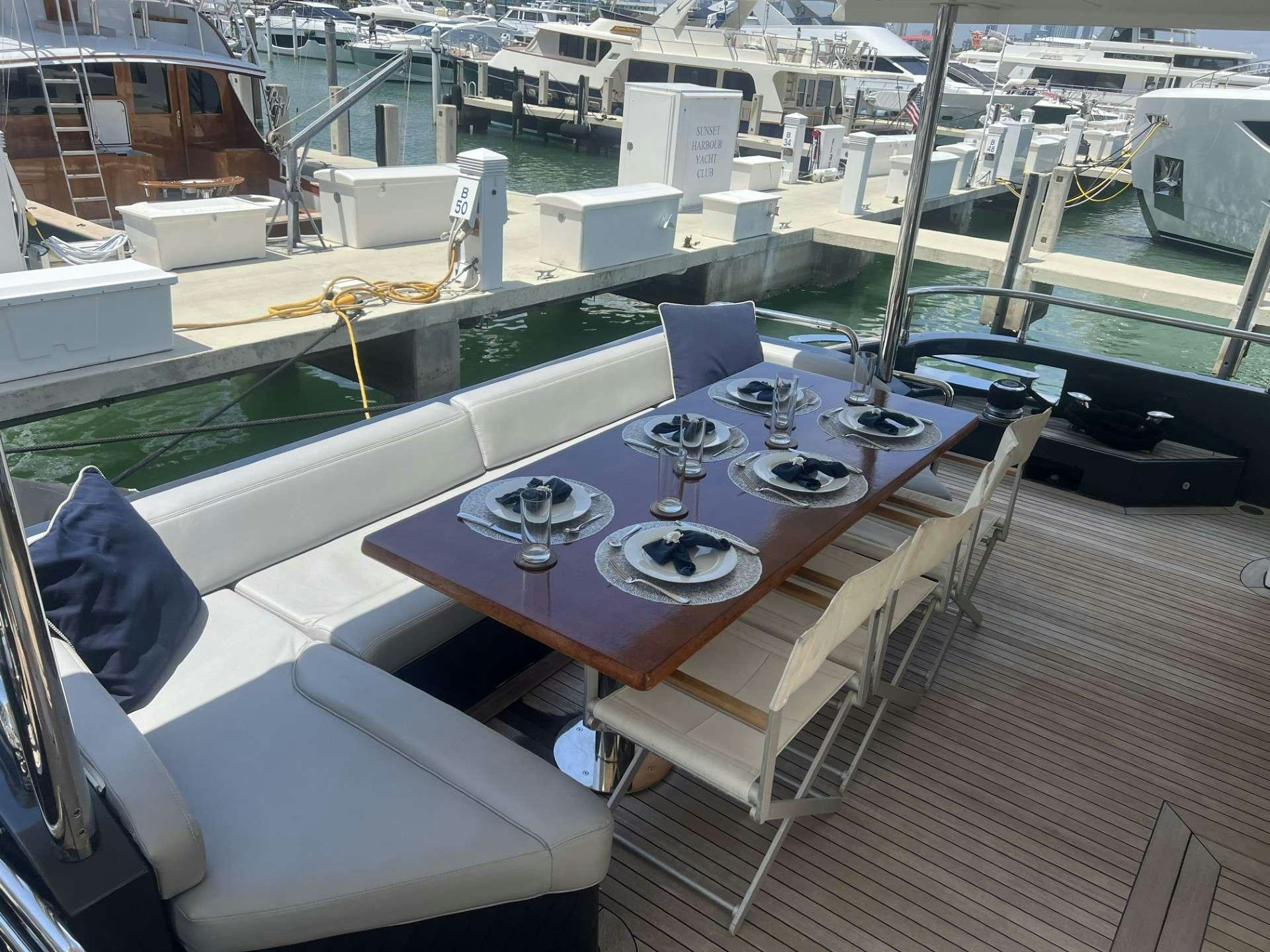 a room with a table and chairs aboard SKY Yacht for Charter