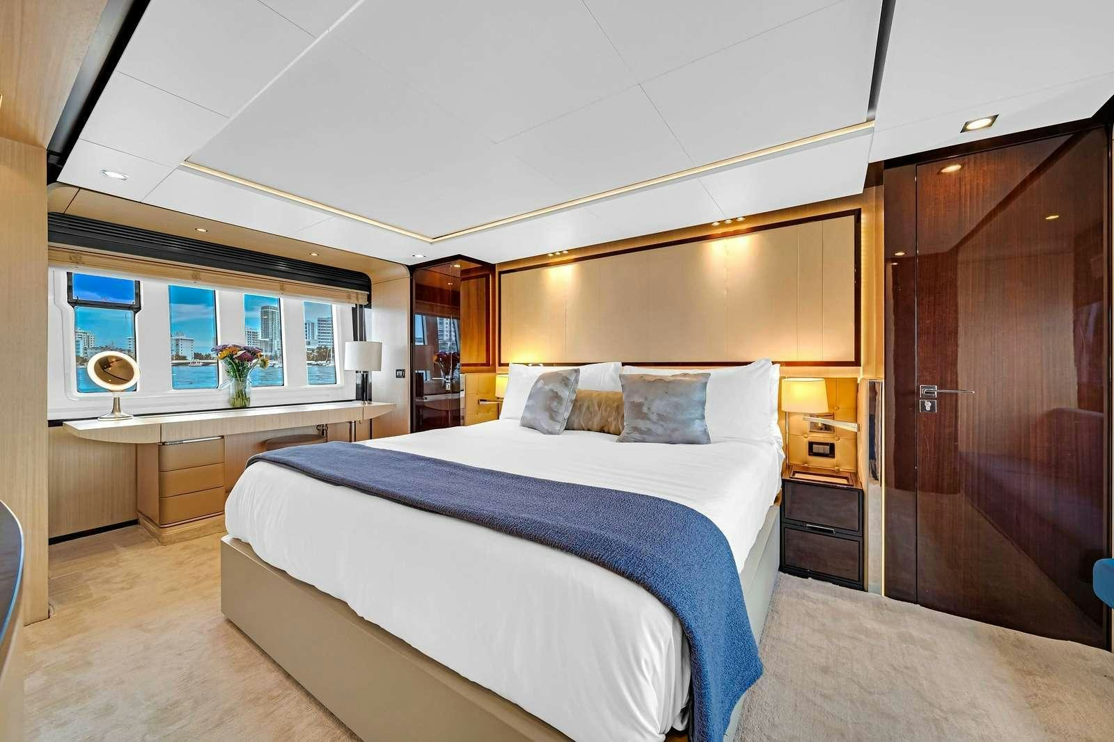 a bedroom with a bed and a desk aboard SKY Yacht for Charter