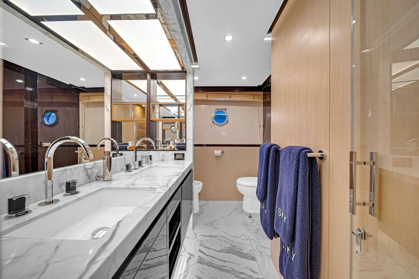 a bathroom with a sink and a mirror aboard SKY Yacht for Charter
