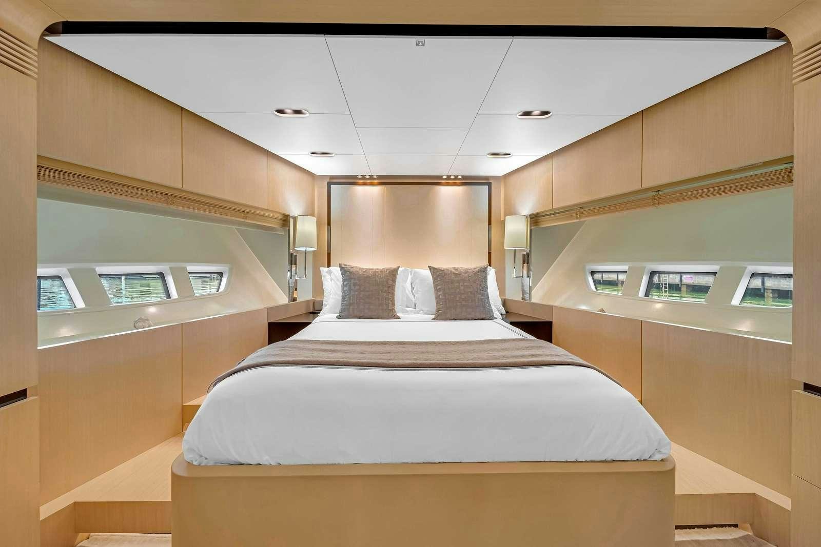 a room with a bed and a window aboard SKY Yacht for Charter