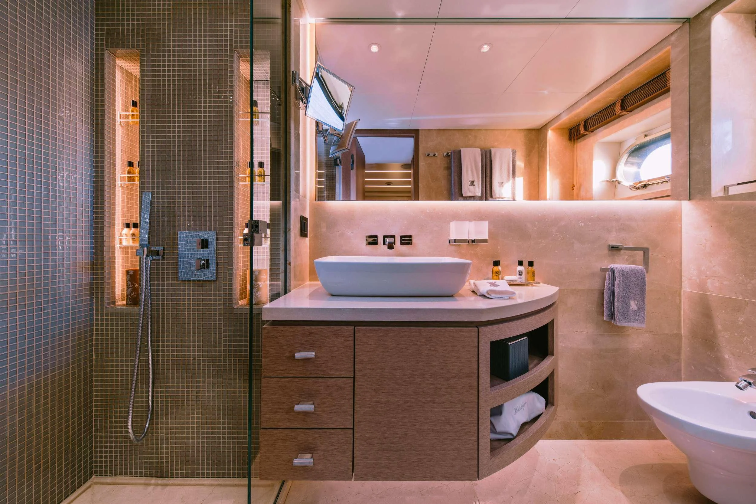 a bathroom with a sink and a mirror aboard XANA Yacht for Charter