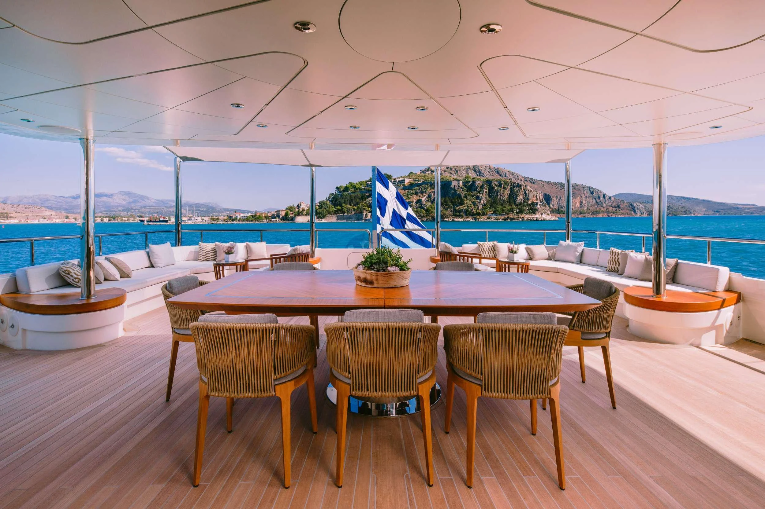 a table and chairs on a deck aboard XANA Yacht for Charter