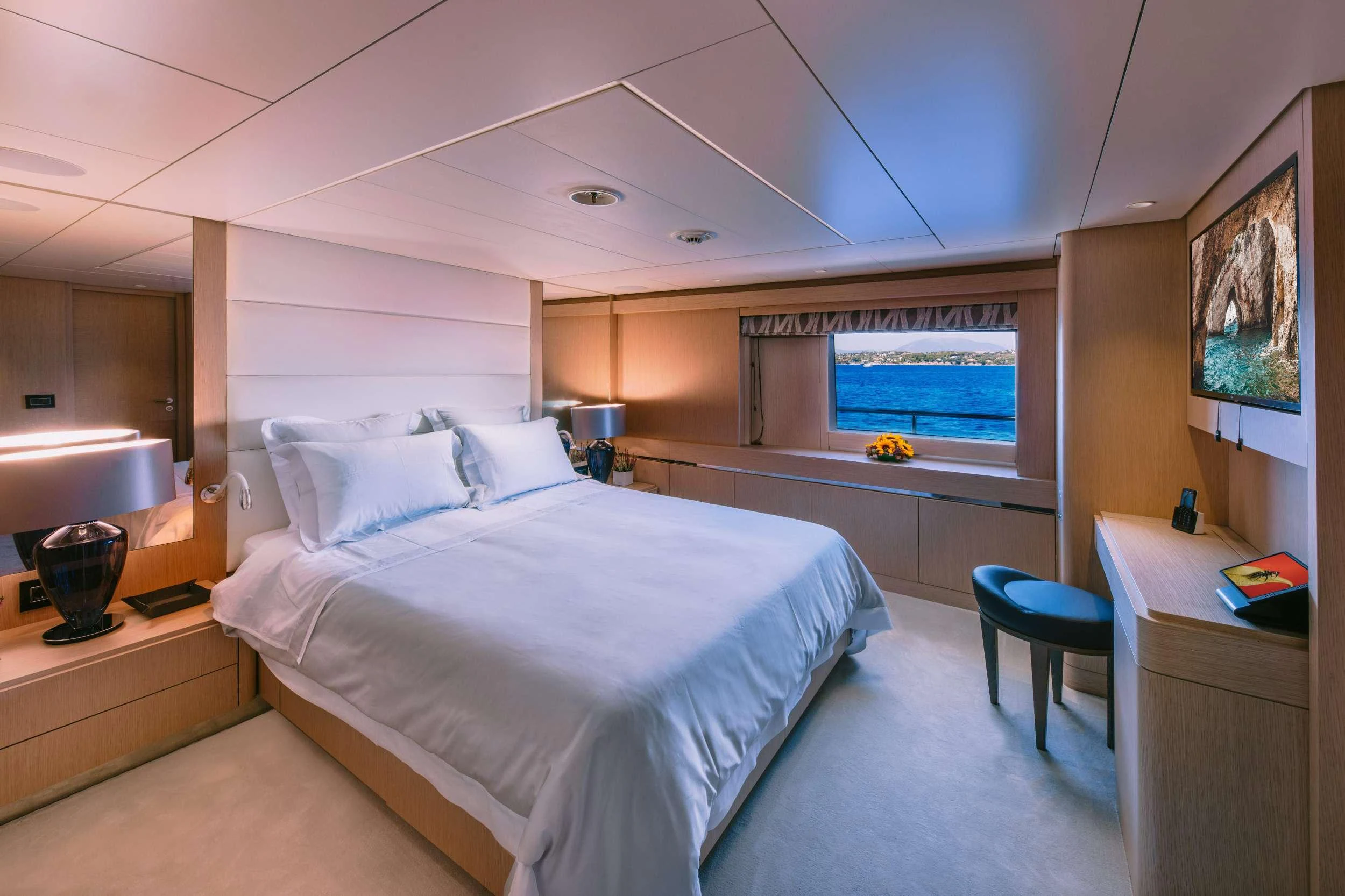 a bedroom with a bed and a desk aboard XANA Yacht for Charter