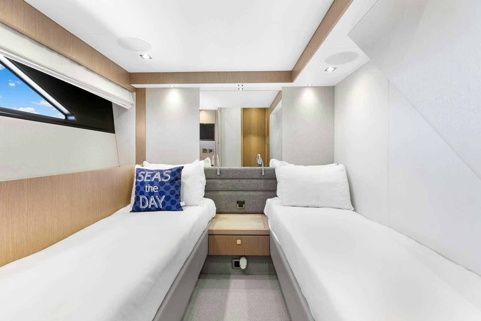 a room with two beds aboard DONE DEAL Yacht for Charter