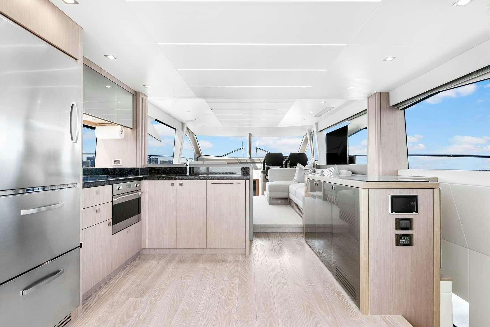 a kitchen with a large refrigerator aboard DONE DEAL Yacht for Charter