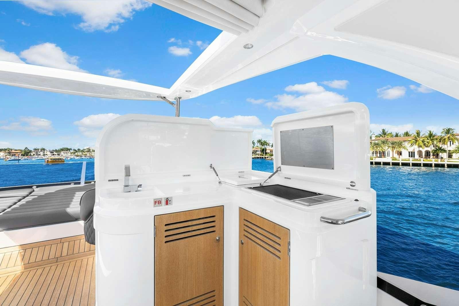 a boat with a television on the deck aboard DONE DEAL Yacht for Charter