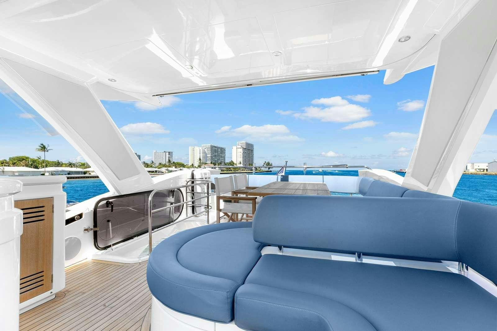 a room with a view of the ocean and a city aboard DONE DEAL Yacht for Charter