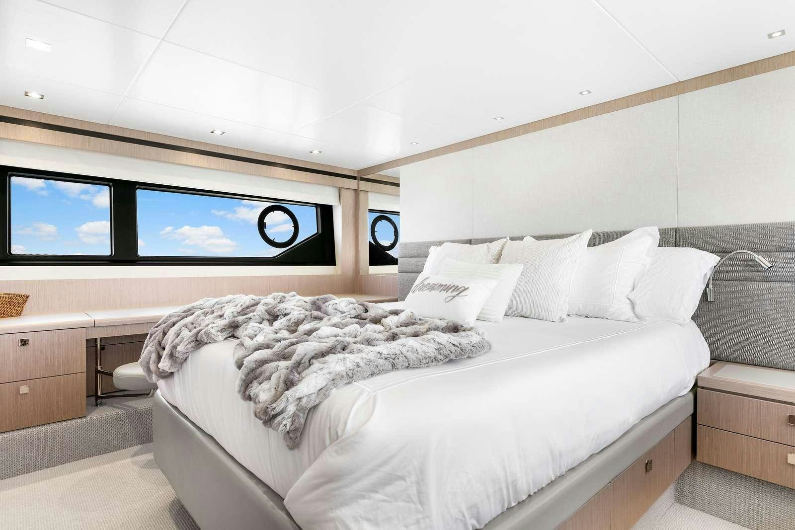 a bed with white sheets aboard DONE DEAL Yacht for Charter