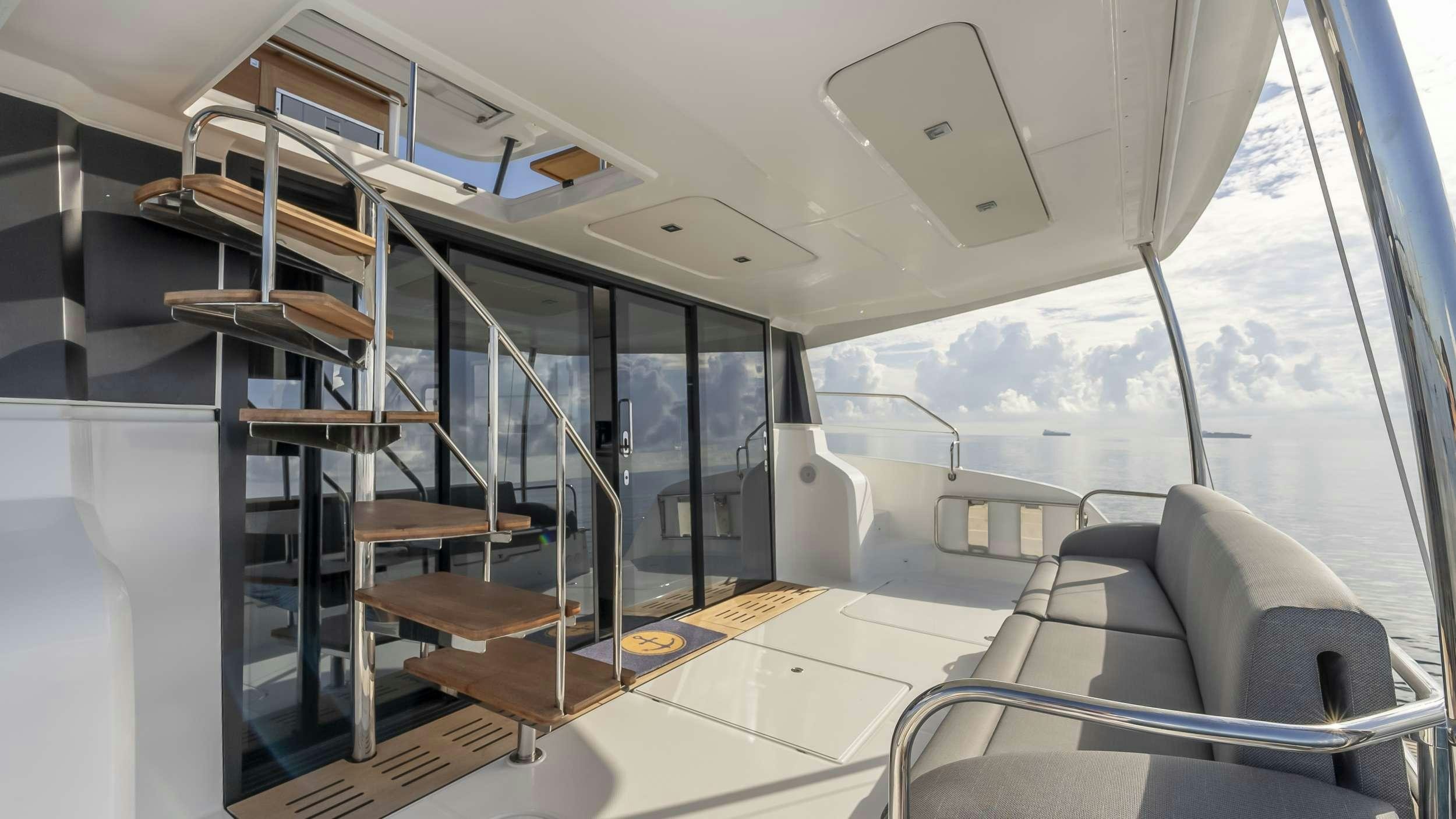 a room with a glass wall and a staircase aboard PRINCESS Yacht for Charter