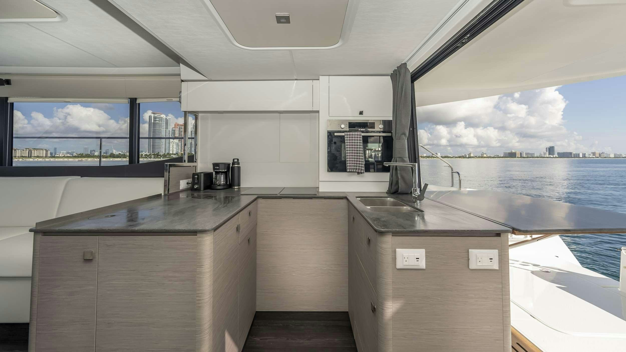 a kitchen with a large window aboard PRINCESS Yacht for Charter