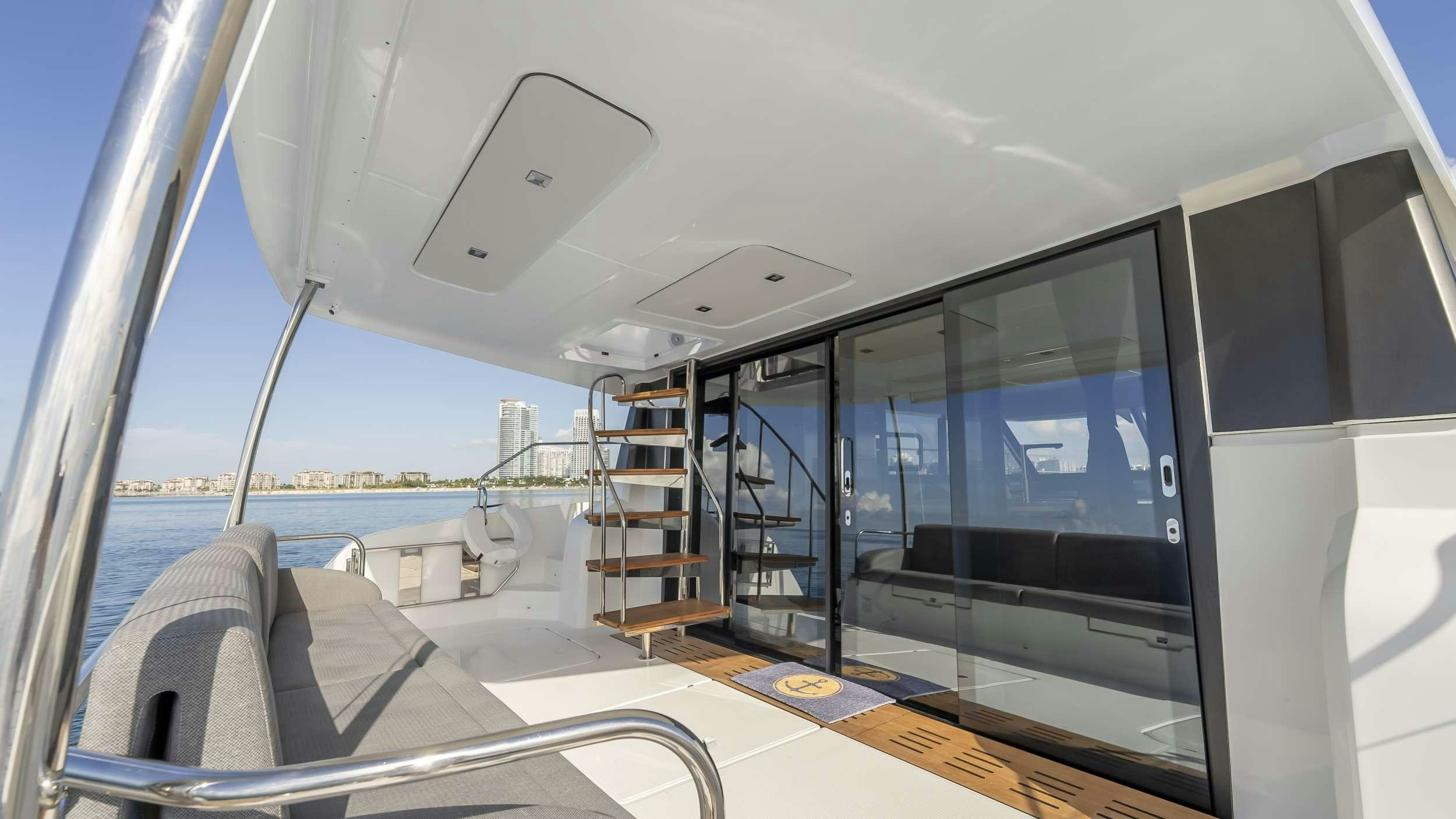 a room with a large glass door and a view of the water aboard PRINCESS Yacht for Charter