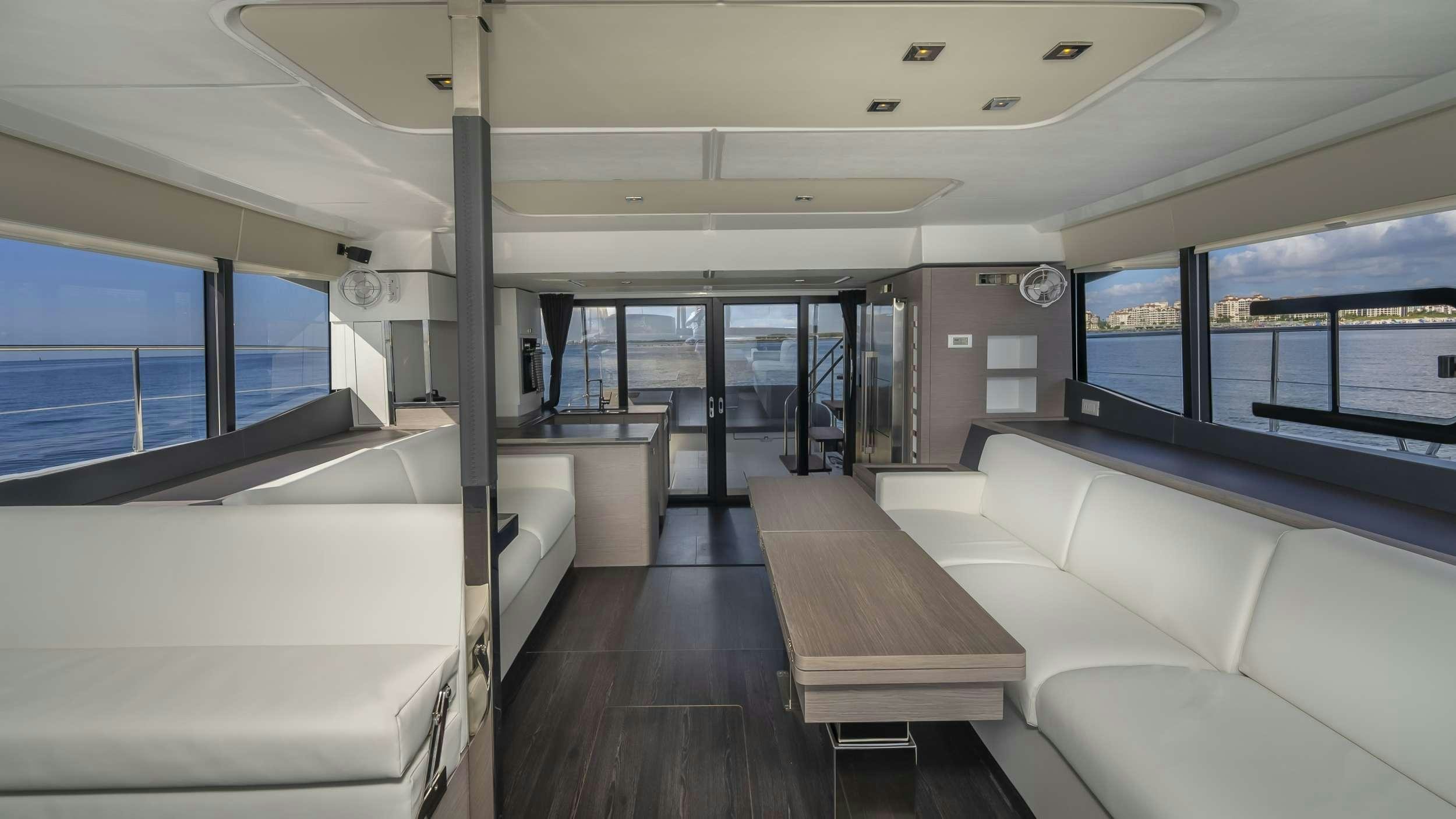 a room with a table and couches aboard PRINCESS Yacht for Charter