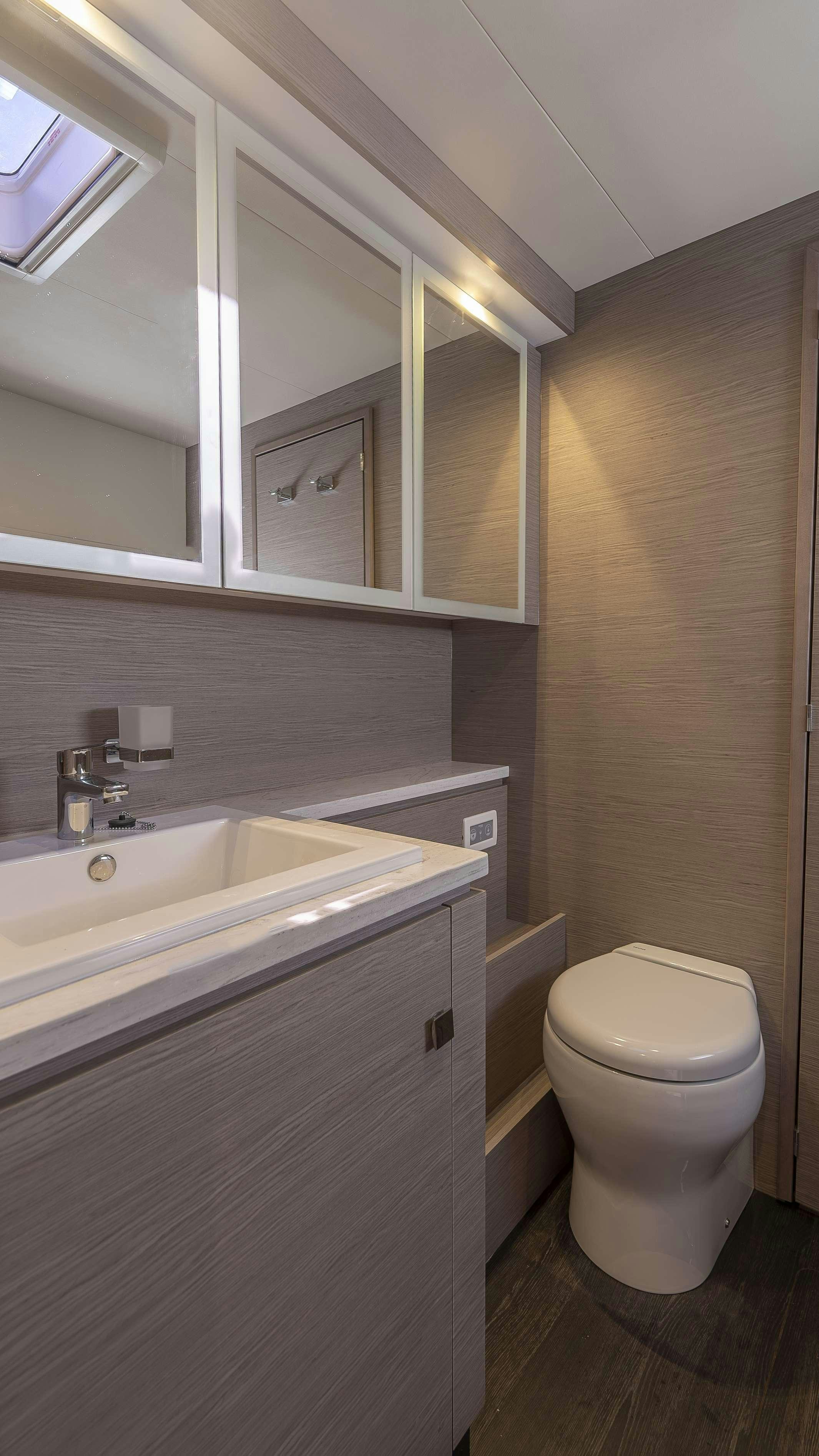 a bathroom with a toilet and sink aboard PRINCESS Yacht for Charter