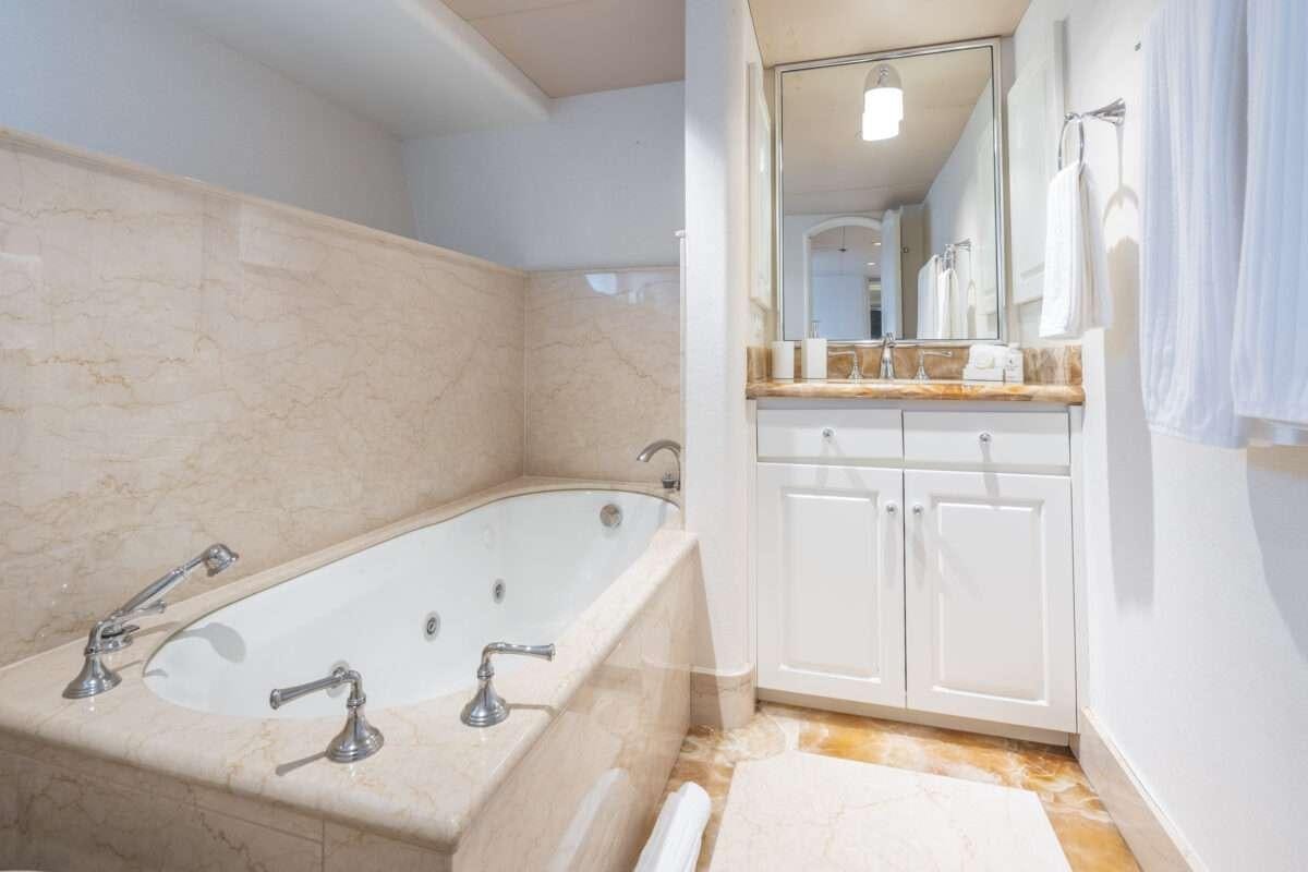 a bathroom with a bathtub and sink aboard CHANSON Yacht for Charter