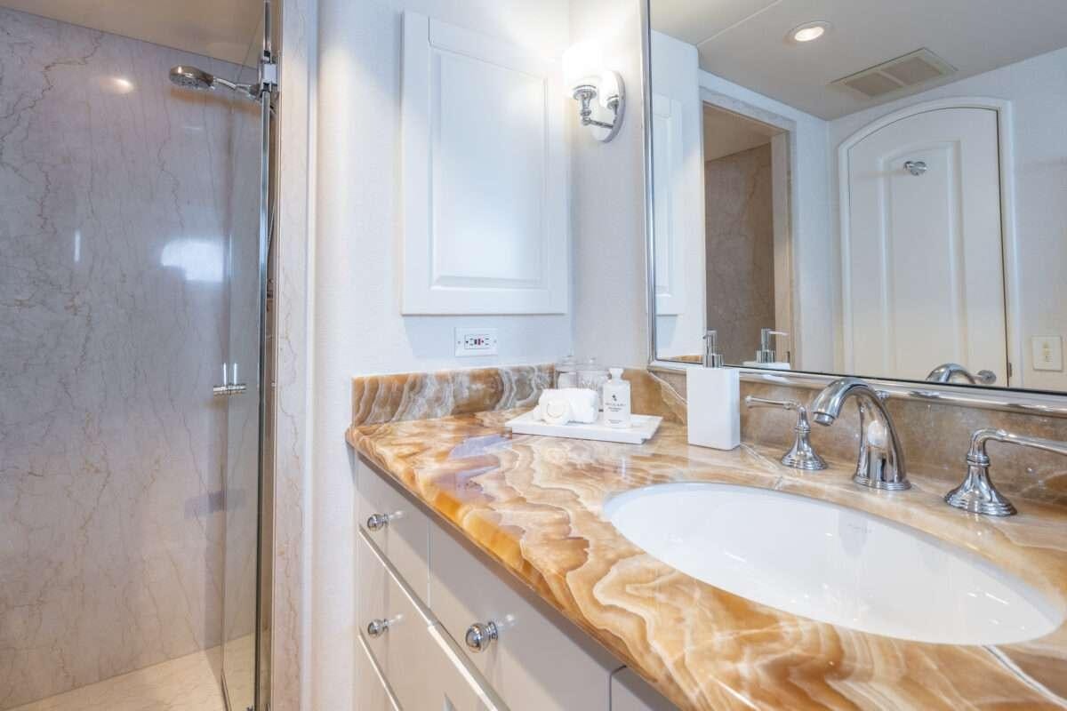 a bathroom with a countertop sink and mirror aboard CHANSON Yacht for Charter