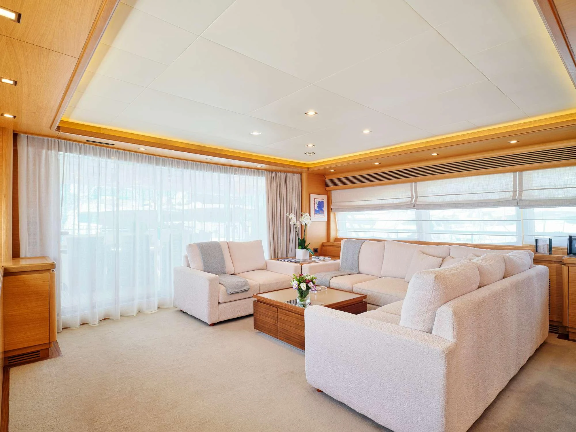 a living room with white furniture aboard WATCH ME Yacht for Charter